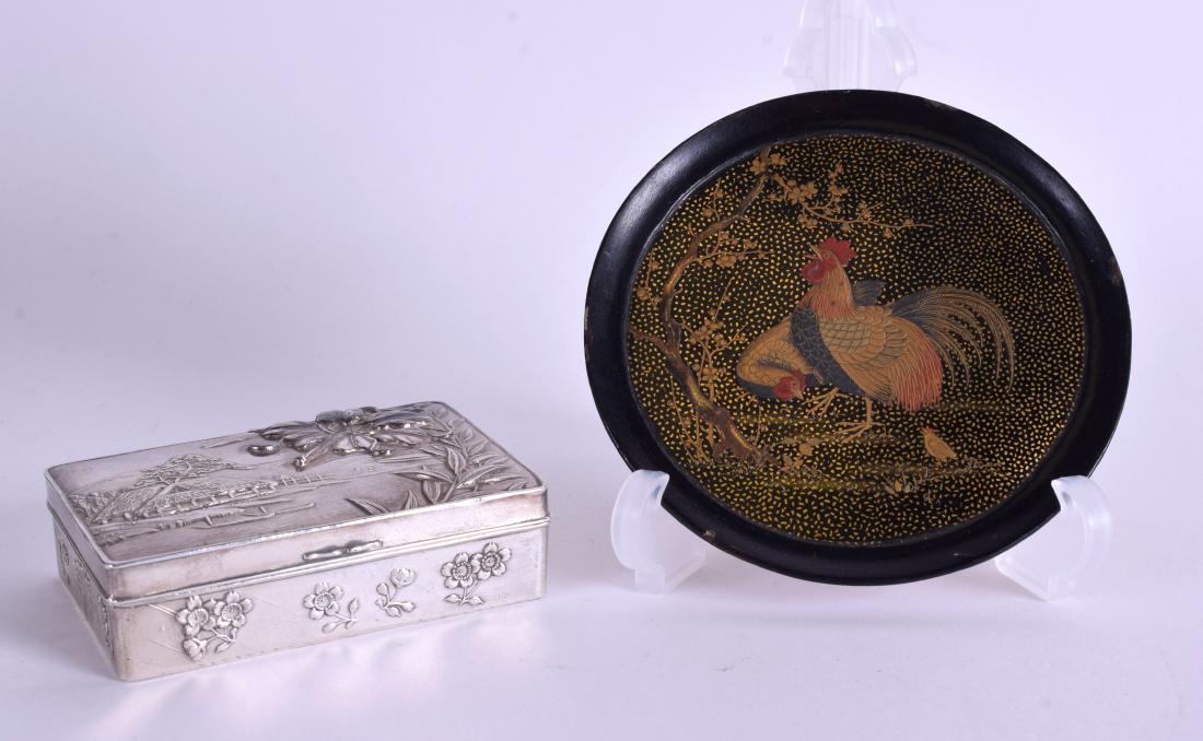 A 19TH CENTURY JAPANESE MEIJI PERIOD BLACK LACQUER DISH: A 19TH CENTURY JAPANESE MEIJI PERIOD BLACK LACQUER DISH decorated with hens, together with a white metal Japanese box. 9 cm & 7 cm wide. (2)