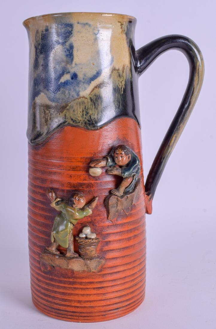 A JAPANESE MEIJI PERIOD SUMIDA GAWA POTTERY JUG: A JAPANESE MEIJI PERIOD SUMIDA GAWA POTTERY JUG decorated with two figures. 24 cm high.