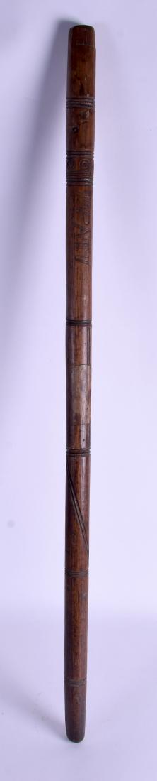 A TRIBAL SOUTHSEA ISLANDS POLYNESIAN CARVED WOOD STAFF: A TRIBAL SOUTHSEA ISLANDS POLYNESIAN CARVED WOOD STAFF incised with swirling motifs. 91 cm long.