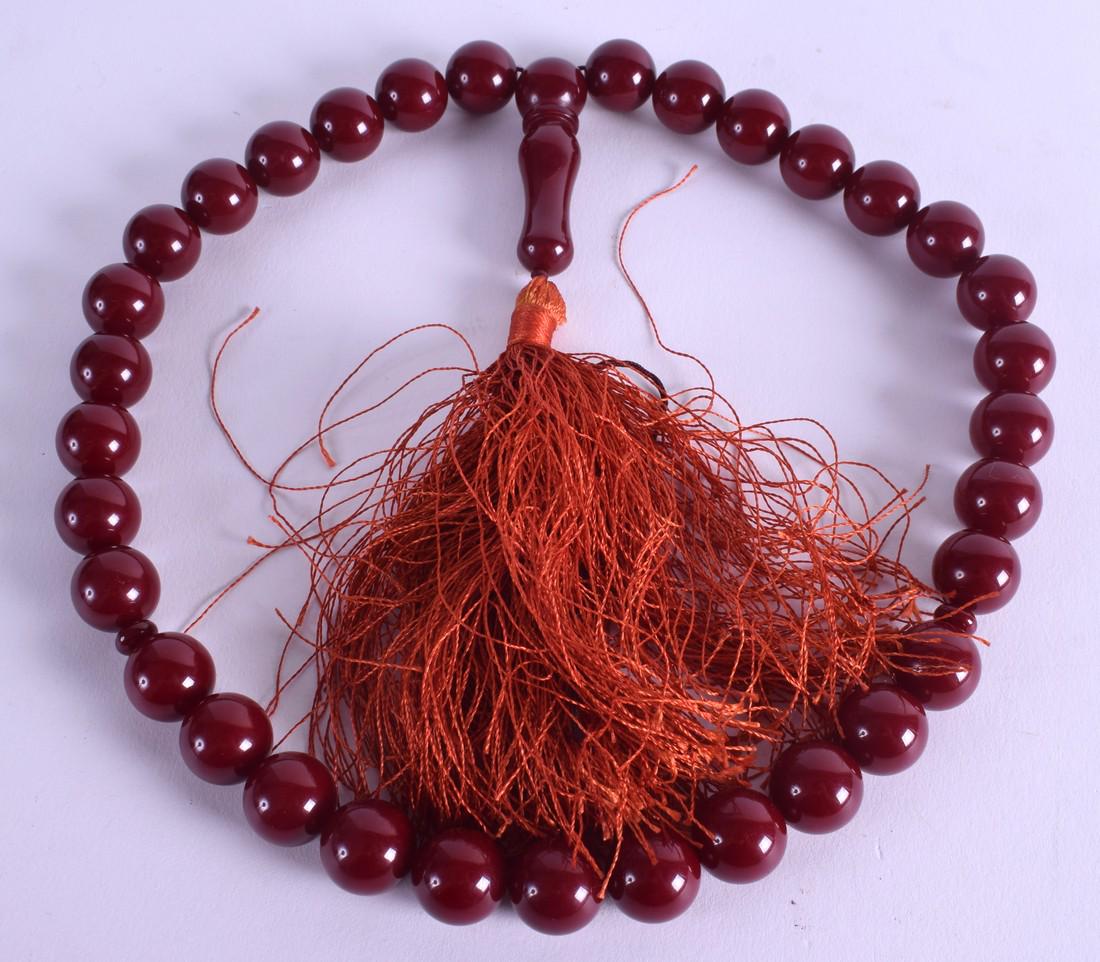 A CHERRY BAKELITE NECKLACE. 100 grams. 60 cm long. (1 of 2)