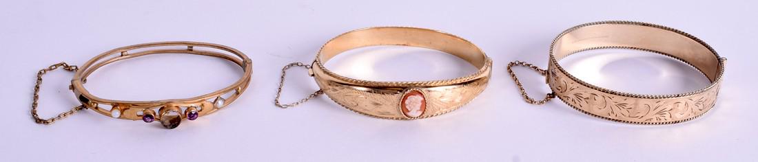 THREE VINTAGE YELLOW METAL BANGLES. (3): THREE VINTAGE YELLOW METAL BANGLES. (3)