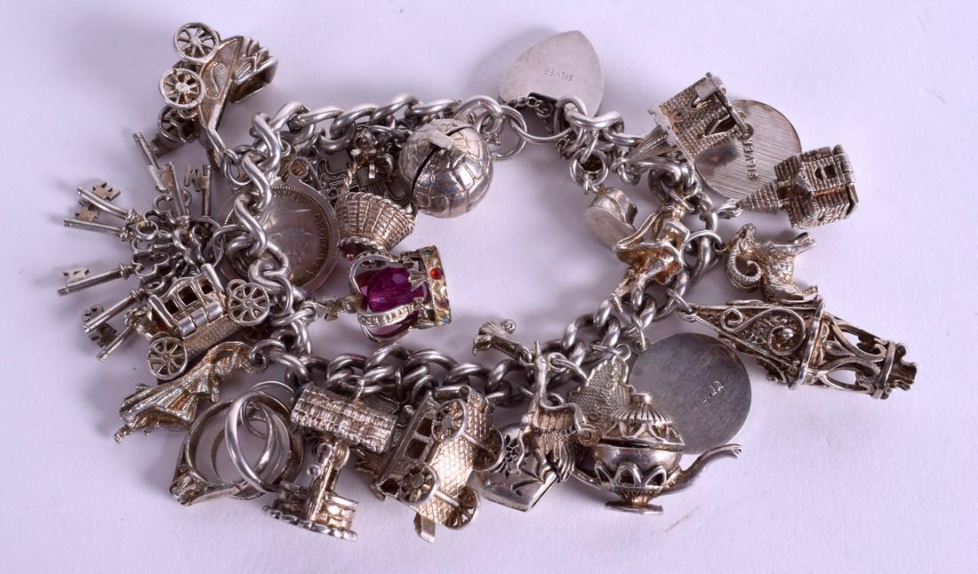 A SILVER CHARM BRACELET. 96 grams. (1 of 2)