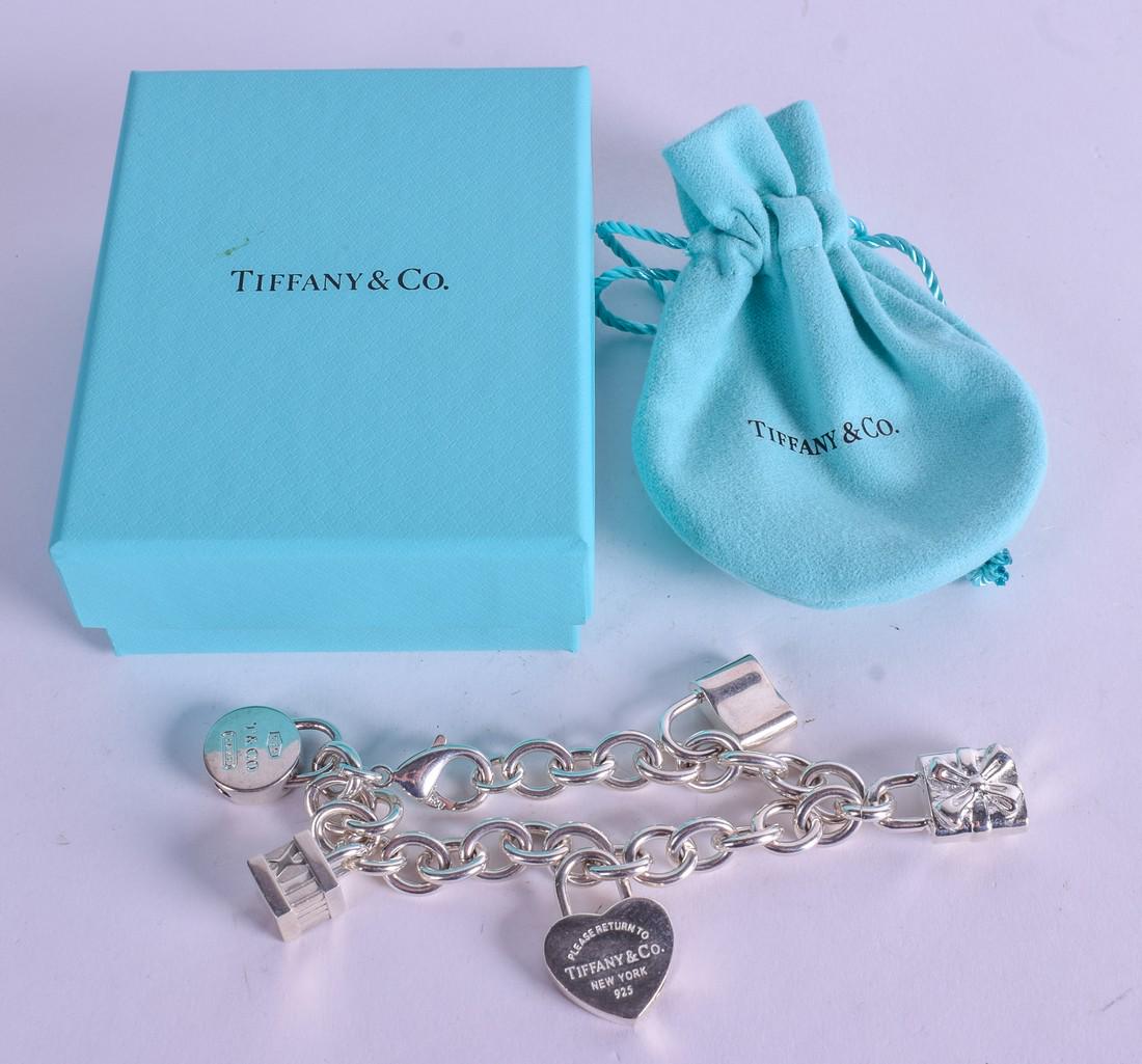 A SILVER TIFFANY CHARM BRACELET. (1 of 3)