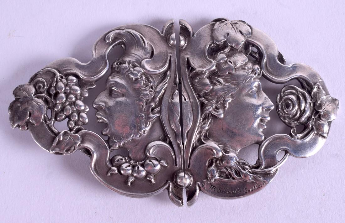 A PAIR OF SOLID SILVER EUROPEAN ART NOUVEAU BUCKLES,: A PAIR OF SOLID SILVER EUROPEAN ART NOUVEAU BUCKLES, forming portraits opposing fruiting vines. 4.75 cm wide.
