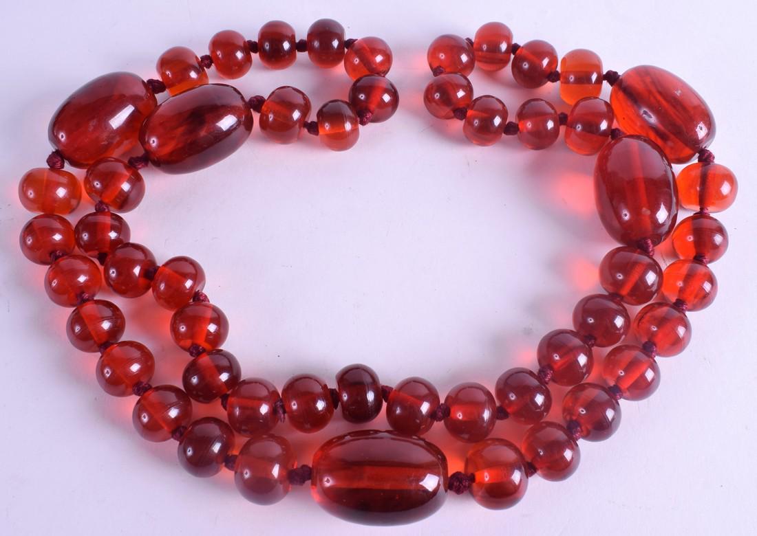 A 1920S RED AMBER TYPE NECKLACE. 290 grams. 110 cm (1 of 2)