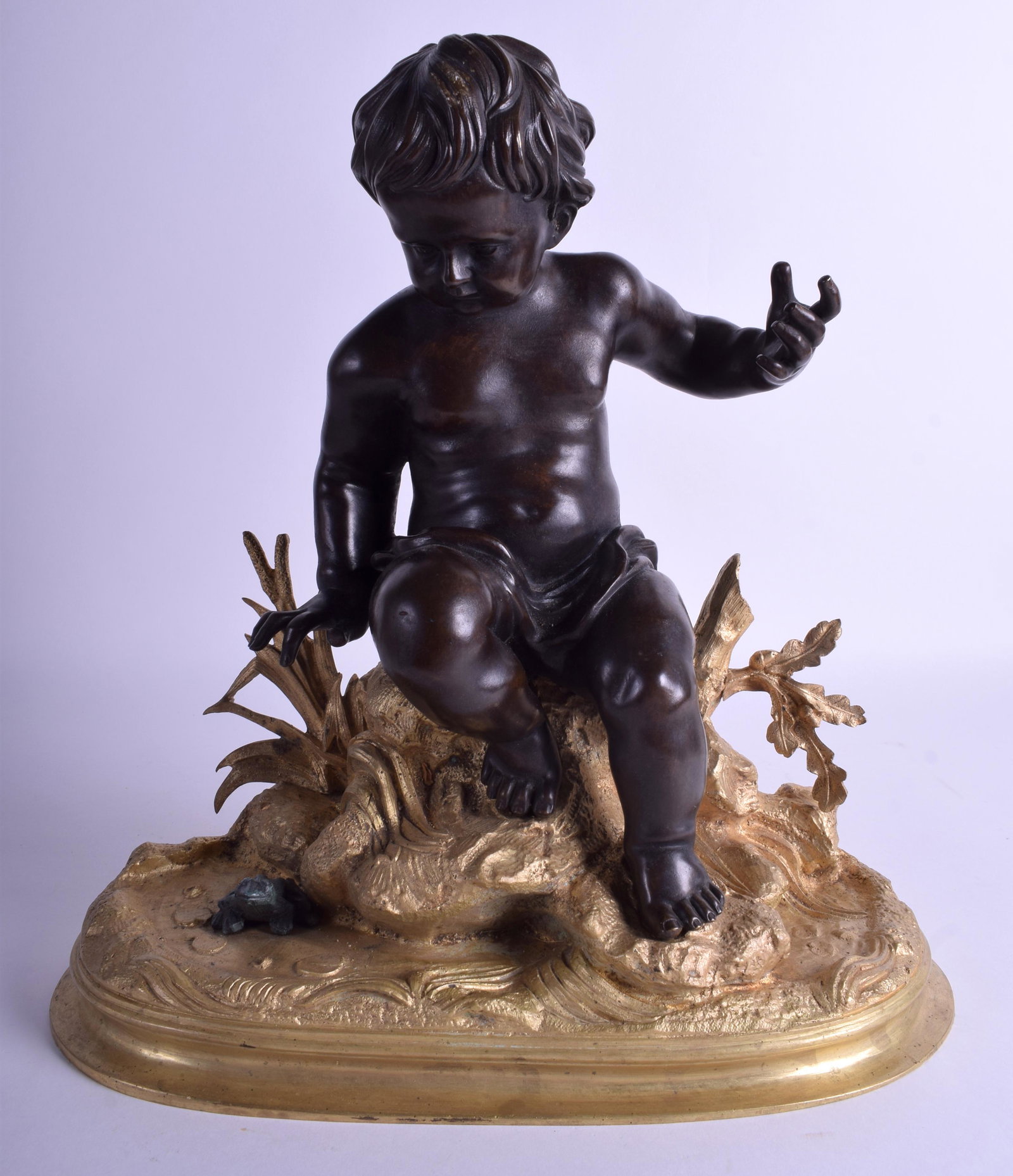 A GOOD EARLY CONTINENTAL BRONZE FIGURE OF A PUTTI: A GOOD EARLY CONTINENTAL BRONZE FIGURE OF A PUTTI Attributed to Francois Duquesnoy (Brussels 1597-1643), Rome, modelled upon an gilded base. 30 cm x 32 cm.