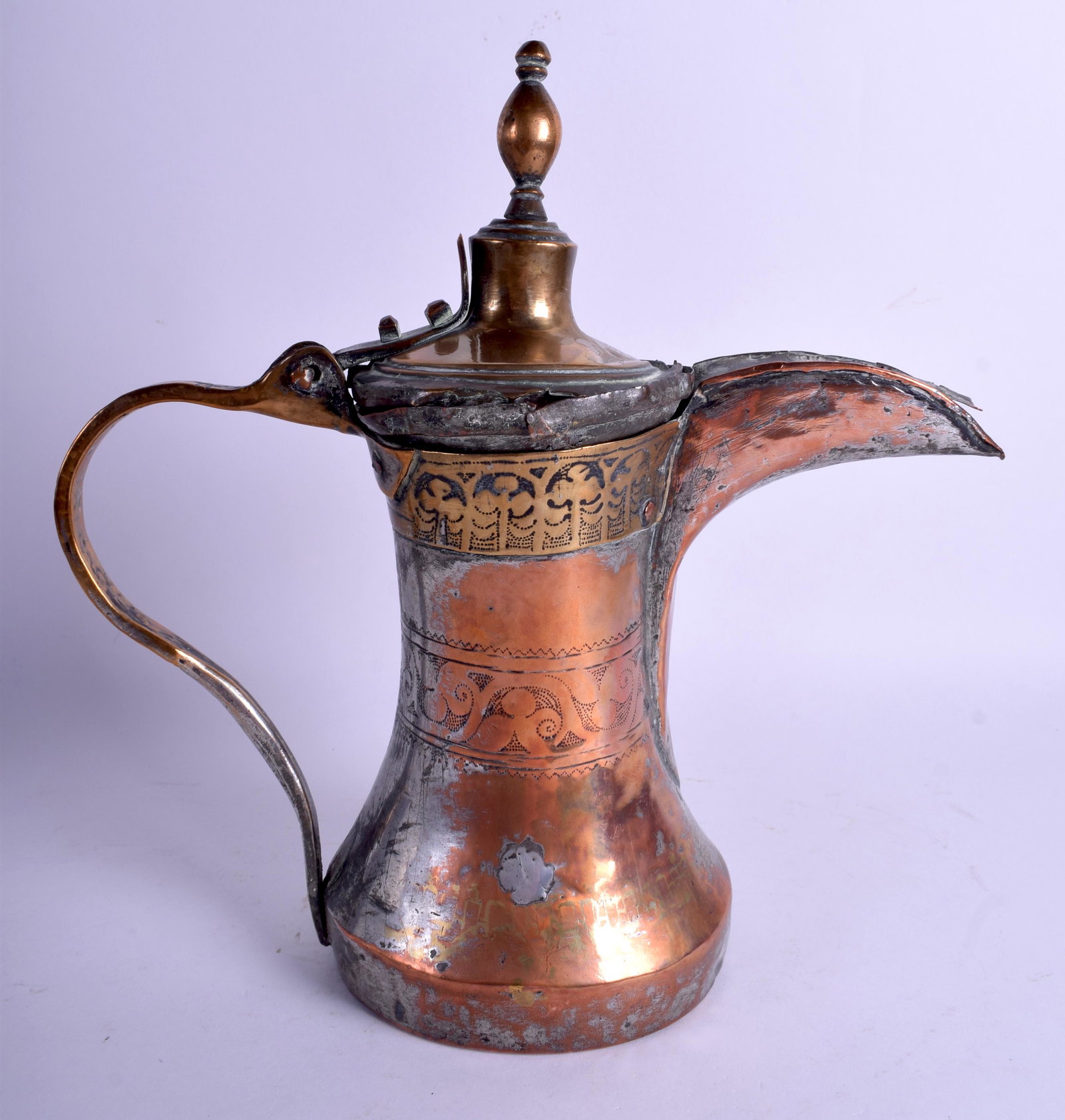 AN EARLY ISLAMIC MIDDLE EASTERN COPPER AND BRASS EWER: AN EARLY ISLAMIC MIDDLE EASTERN COPPER AND BRASS EWER decorated with foliage and motifs. 28 cm high.