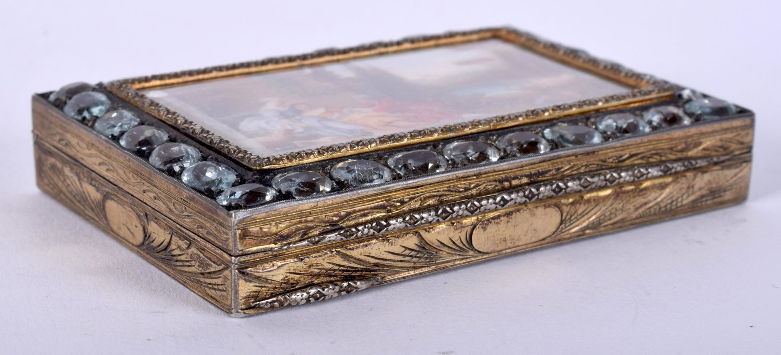 AN ANTIQUE CONTINENTAL SILVER AND EROTIC SNUFF BOX: AN ANTIQUE CONTINENTAL SILVER AND EROTIC SNUFF BOX inset with blue gem stones. 109.8 grams. 8 cm x 5.5 cm.