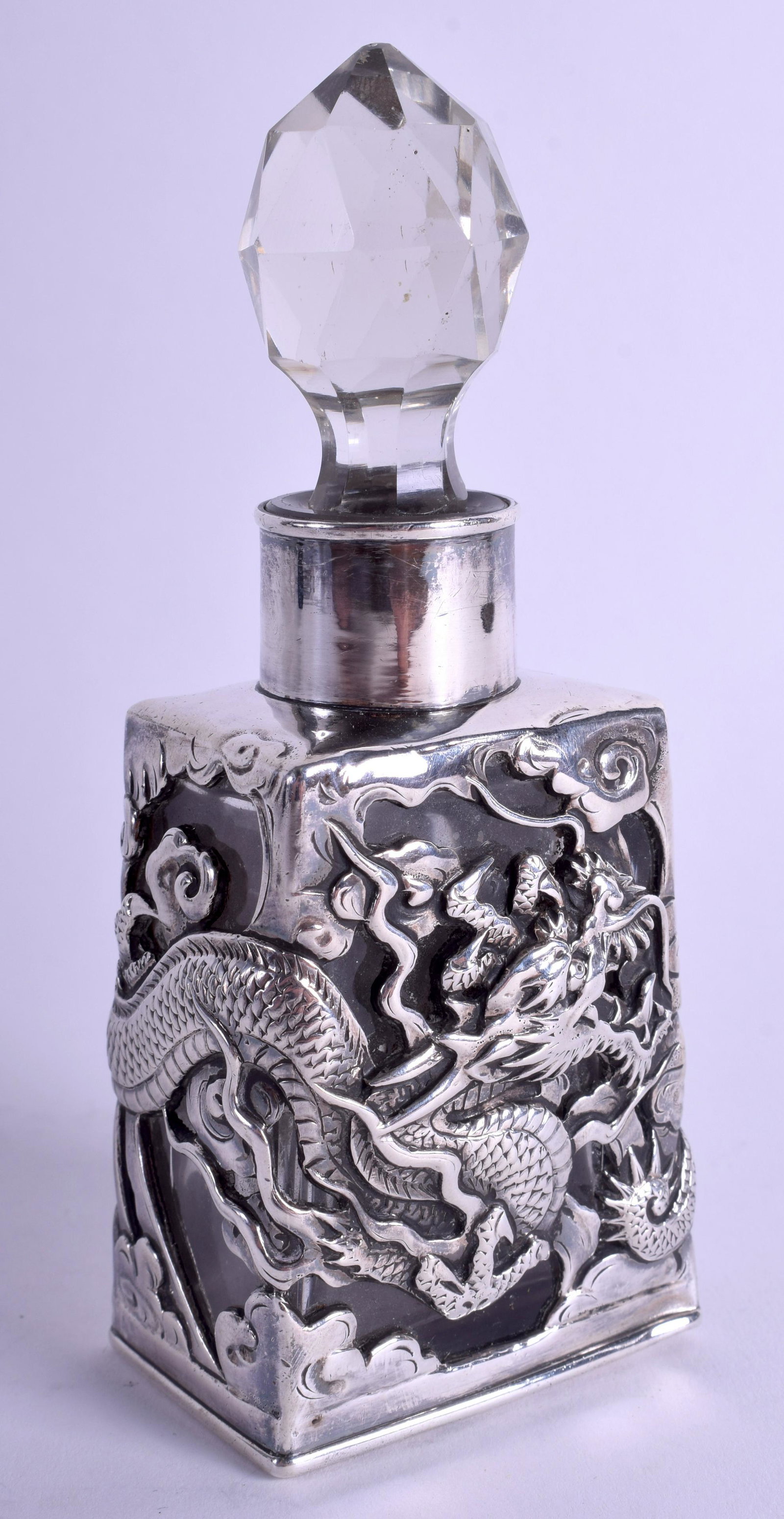 A 19TH CENTURY JAPANESE MEIJI PERIOD YOKOHAMA SILVER: A 19TH CENTURY JAPANESE MEIJI PERIOD YOKOHAMA SILVER OVERLAID SCENT BOTTLE decorated with dragons. 14 cm high.
