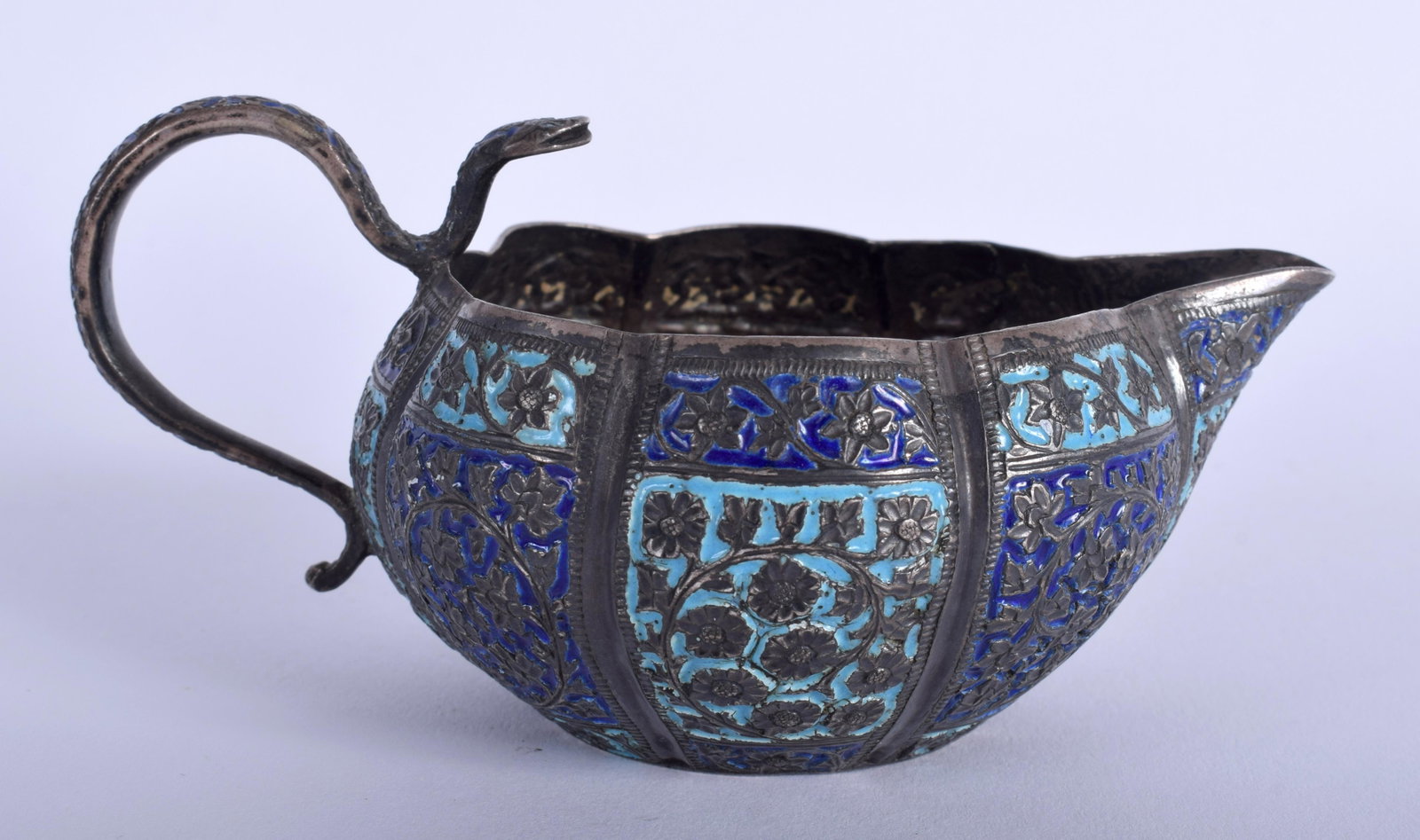 AN ANTIQUE INDIAN ENAMELLED SILVER JUG. 113 grams. 12: AN ANTIQUE INDIAN ENAMELLED SILVER JUG. 113 grams. 12 cm wide.