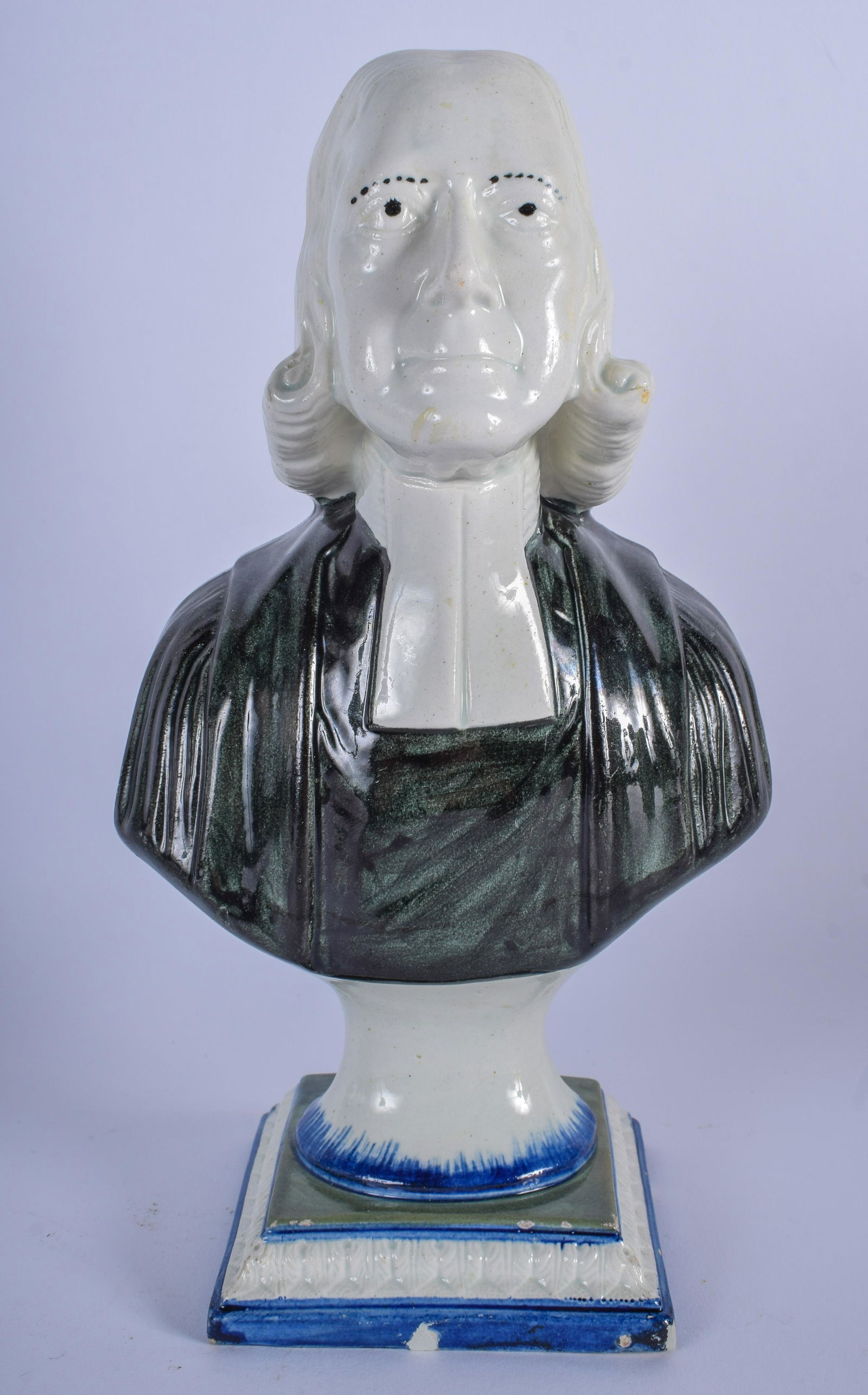 AN EARLY 19TH CENTURY PEARLWARE BUST OF JOHN WESLEY,: AN EARLY 19TH CENTURY PEARLWARE BUST OF JOHN WESLEY, formed upon a lobed base. 25 cm high.