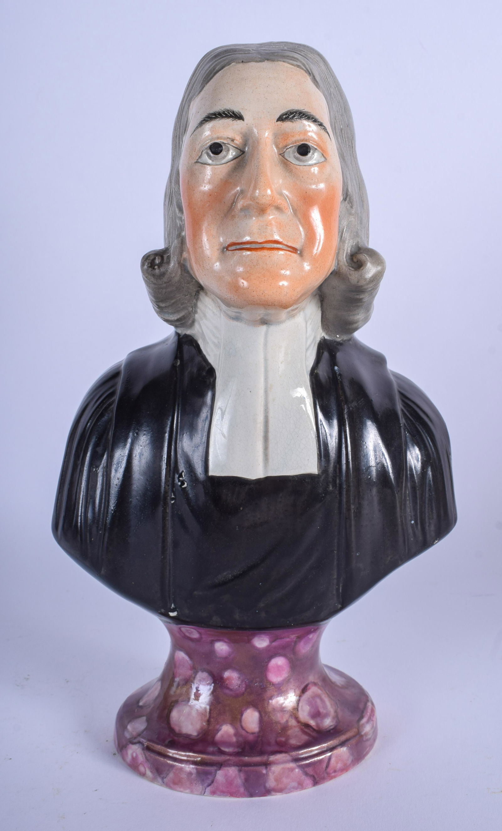 ATTRIBUTED TO OBADIAH SHERRATT EARLY 19TH CENTURY: ATTRIBUTED TO OBADIAH SHERRATT EARLY 19TH CENTURY STAFFORDSHIRE PEARLWARE BUST OF JOHN WESLEY, formed upon a “marbled” plinth. 26 cm high.
