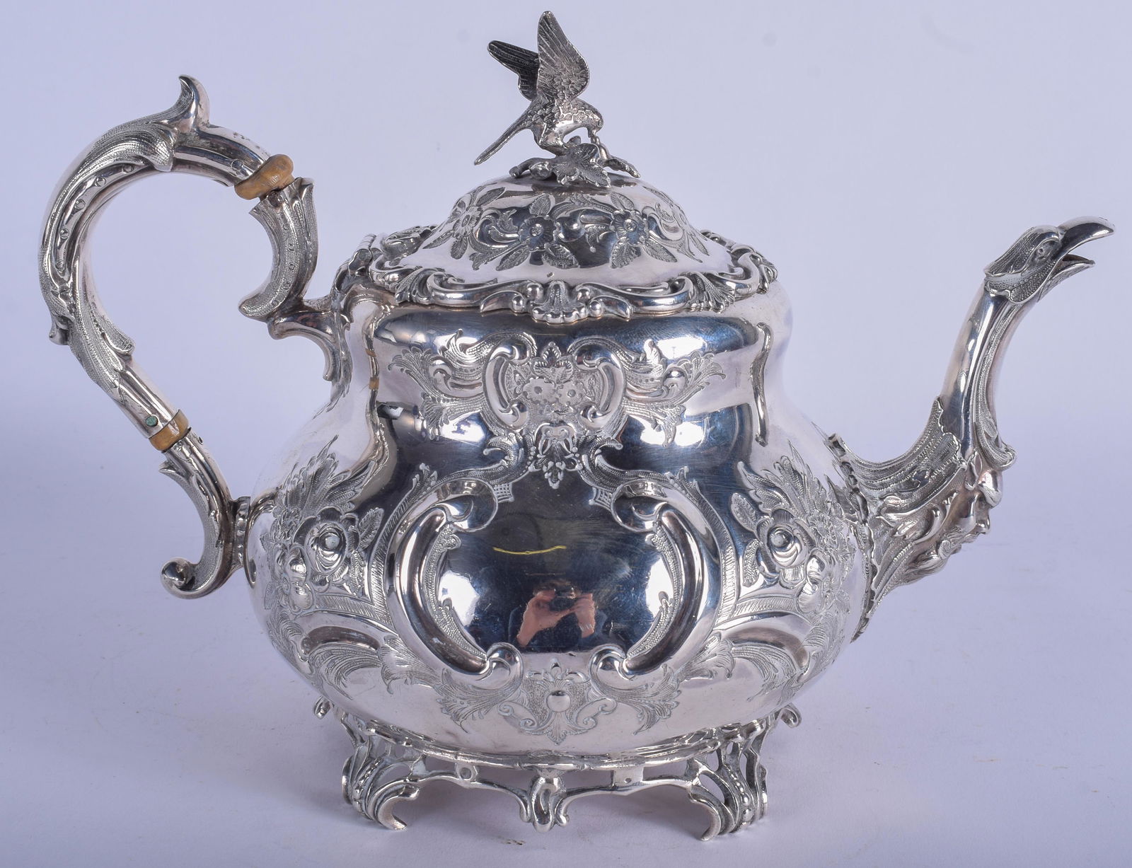 A GOOD ANTIQUE SILVER TEAPOT decorated with foliage. (1 of 3)