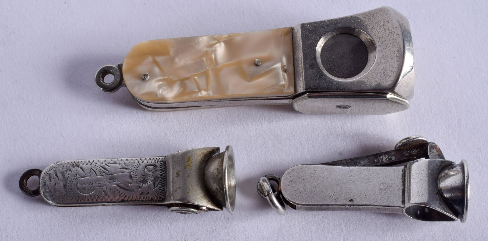 AN ANTIQUE ENGLISH SILVER CIGAR CUTTER together with (1 of 3)