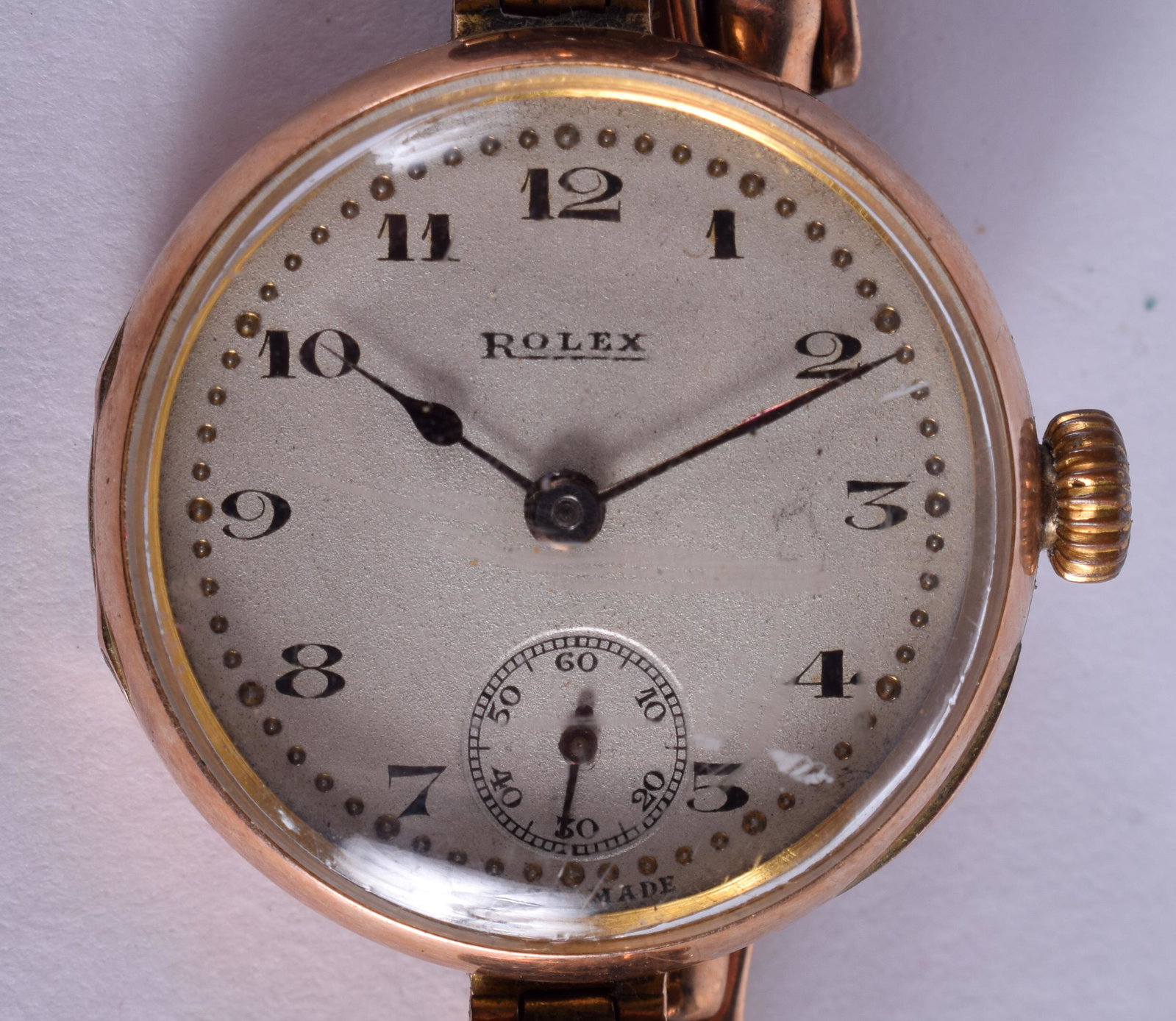 A VINTAGE 9CT GOLD ROLEX with rose gold strap. 19.7: A VINTAGE 9CT GOLD ROLEX with rose gold strap. 19.7 grams overall. 2.25 cm diameter.