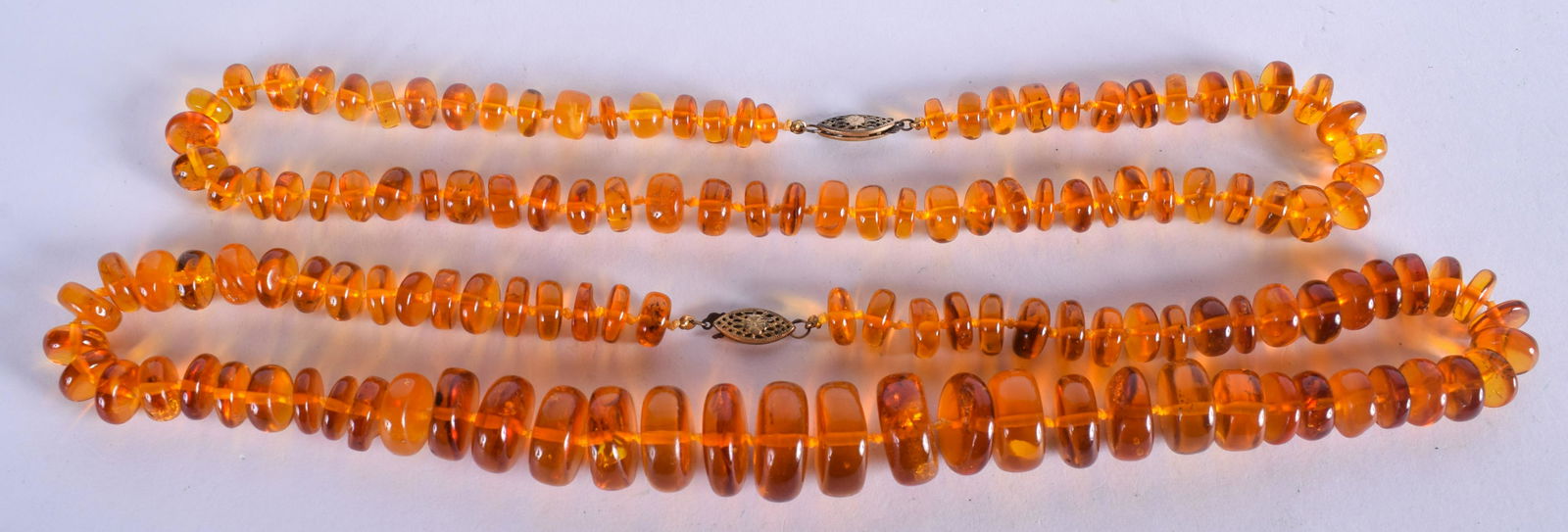 TWO STRINGS OF AMBER. (2) (1 of 3)