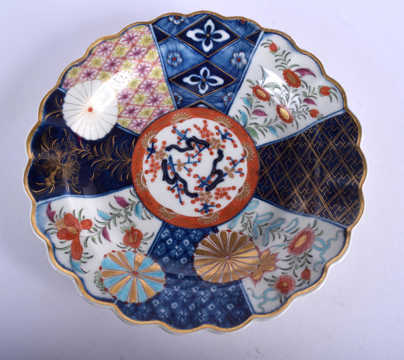 A 18TH CENTURY WORCESTER SCALLOPED PLATE of Old Mosaic: A 18TH CENTURY WORCESTER SCALLOPED PLATE of Old Mosaic type painted with fan panel in Japanese imari style. 19.5 cm wide