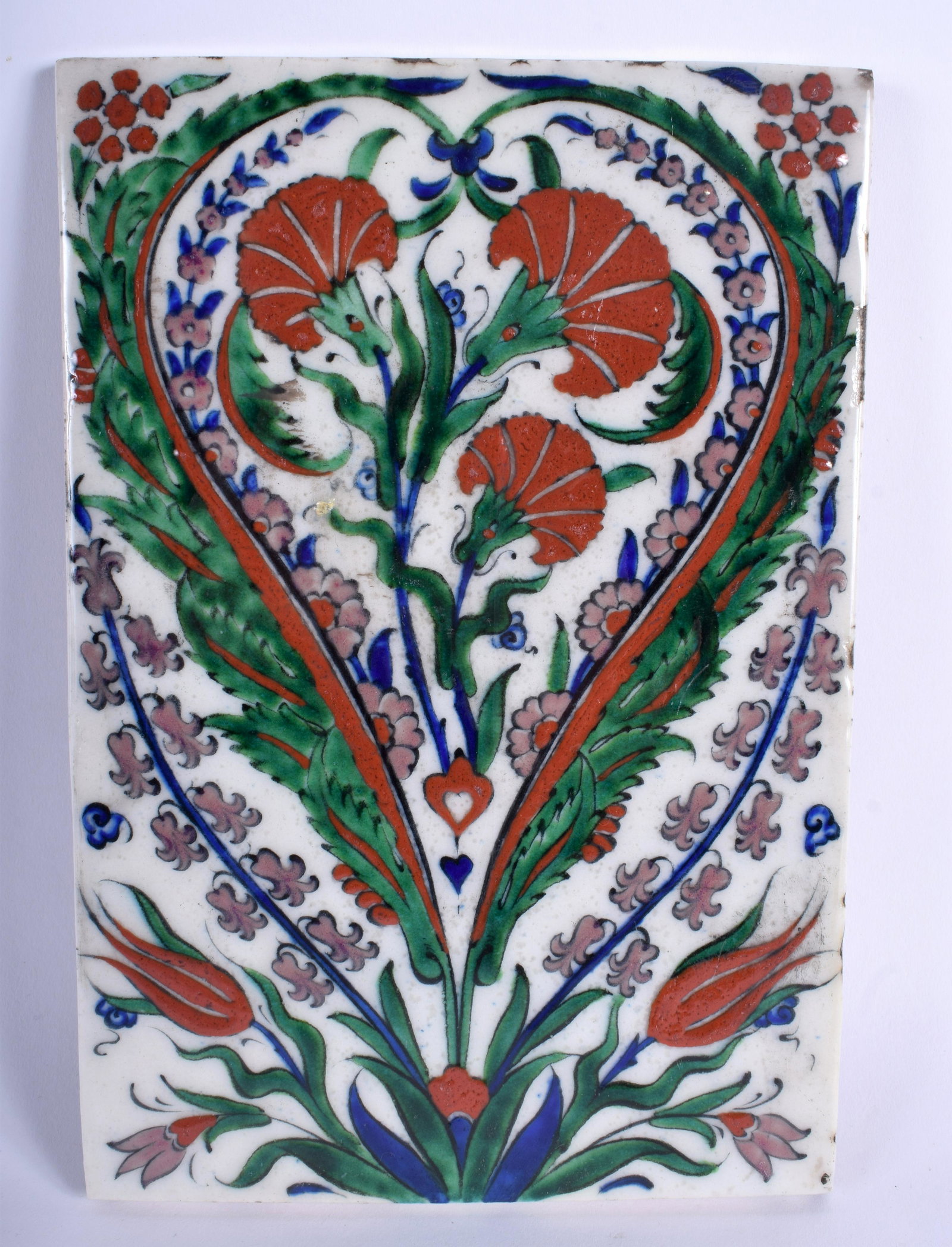 A MIDDLE EASTERN IZNIK FAIENCE POTTERY TILE painted: A MIDDLE EASTERN IZNIK FAIENCE POTTERY TILE painted with floral sprays. 16 cm x 23 cm.