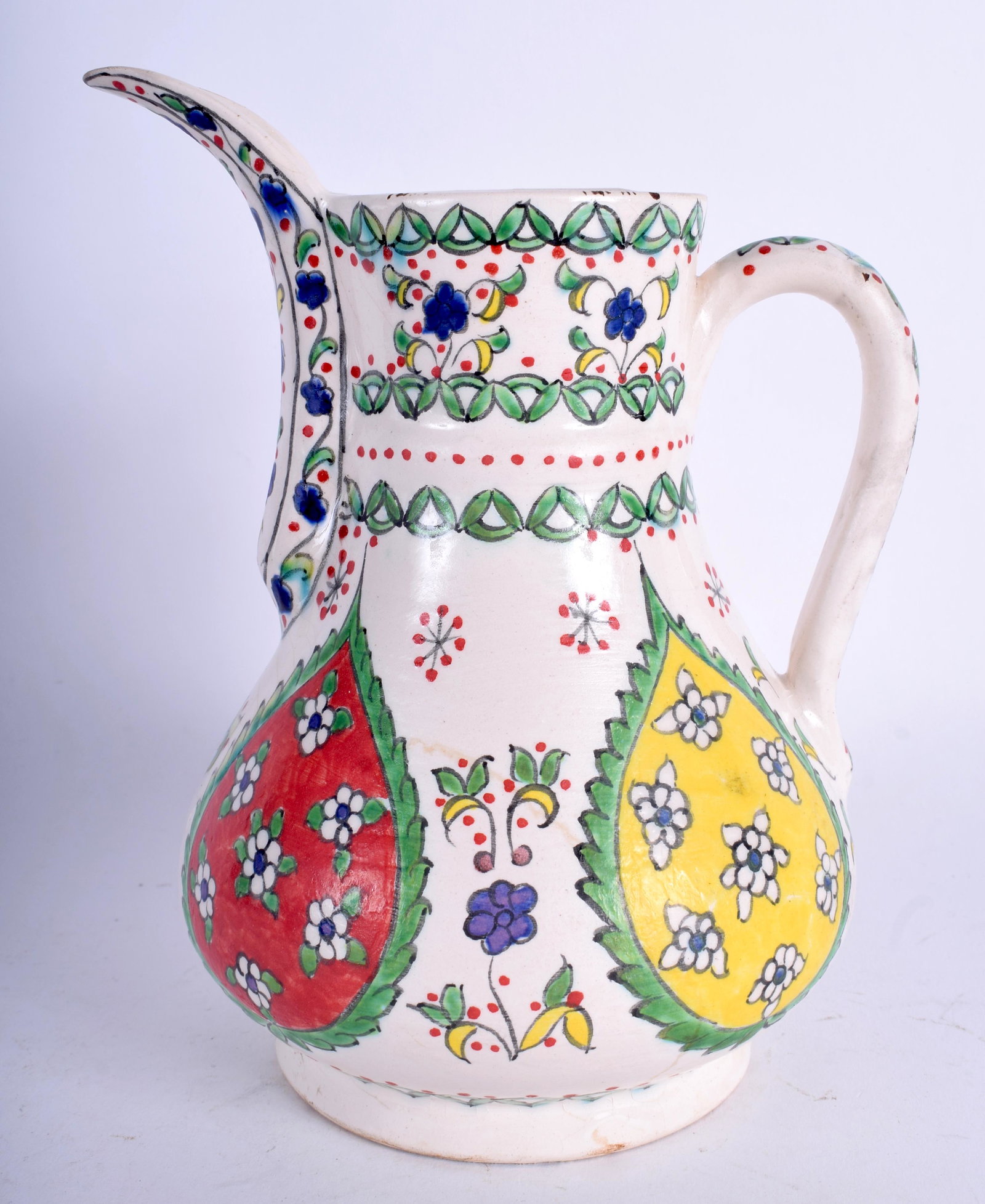 A MIDDLE EASTERN TURKISH KUTAHYA FAIENCE COFFEE POT: A MIDDLE EASTERN TURKISH KUTAHYA FAIENCE COFFEE POT painted with floral sprays. 18 cm high.