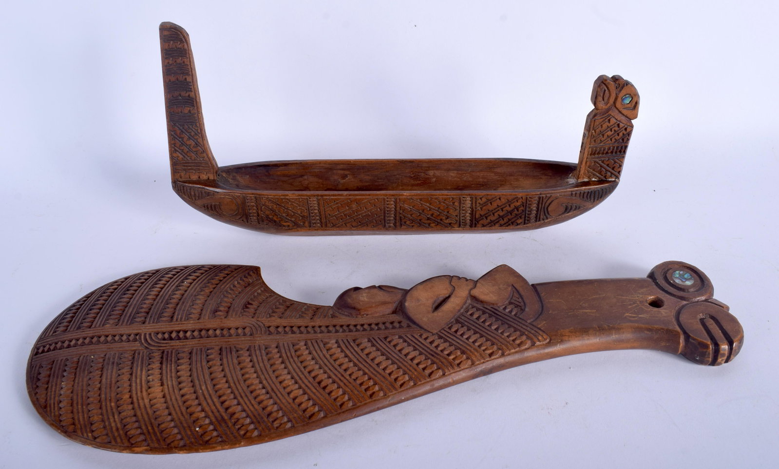 A VINTAGE SOUTHSEA ISLANDS MAORI TRIBAL BOAT together: A VINTAGE SOUTHSEA ISLANDS MAORI TRIBAL BOAT together with a figural tribal weapon. 29 cm & 37 cm long. (2)