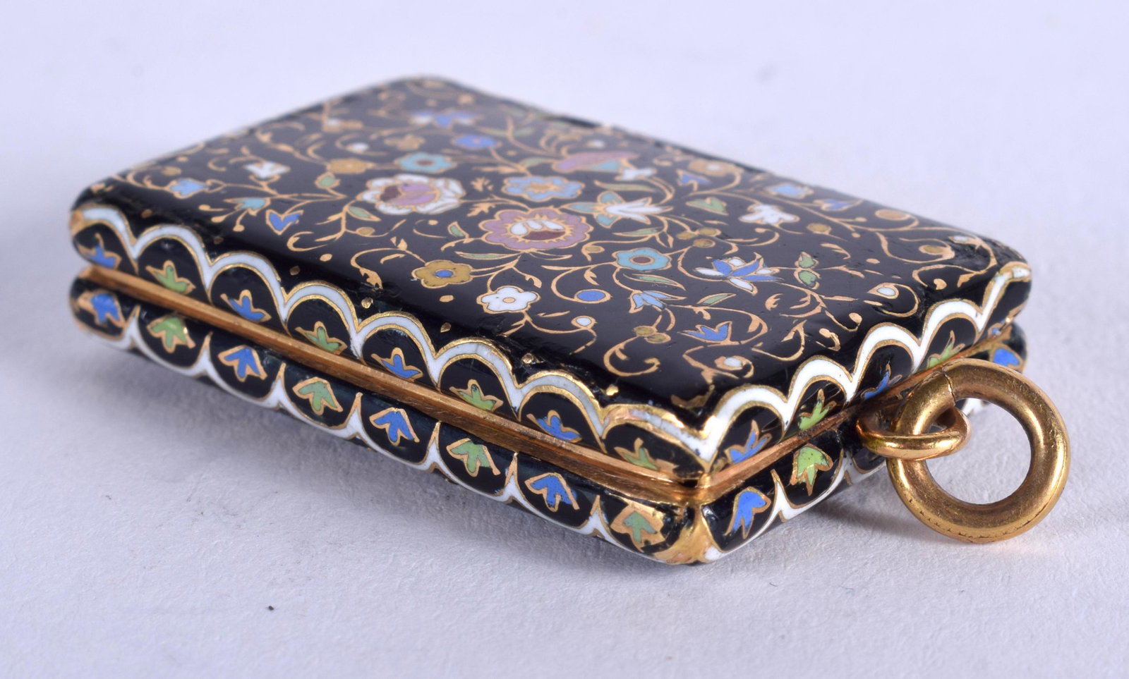 A VERY RARE 19TH CENTURY GOLD AND ENAMEL VINAIGRETTE: A VERY RARE 19TH CENTURY GOLD AND ENAMEL VINAIGRETTE probably 18ct, painted with floral scrolls. 13.6 grams. 3.5 cm x 2.5 cm.