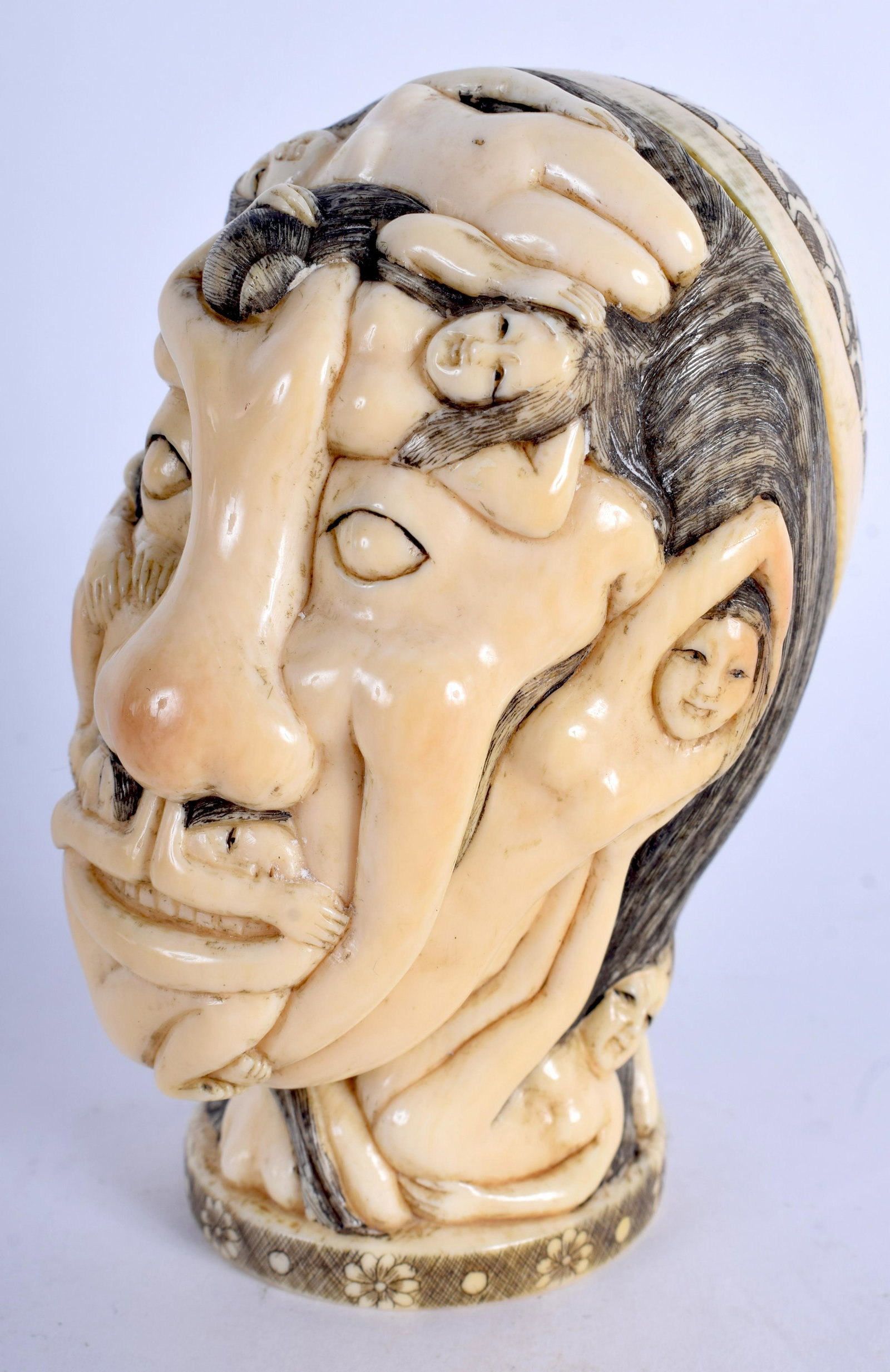 A RARE EARLY 20TH CENTURY CHINESE CARVED BOX AND COVER: A RARE EARLY 20TH CENTURY CHINESE CARVED BOX AND COVER overlaid with erotic figures in various pursuits, the head sliding to reveal a vacant interior. 11 cm x 4 cm.