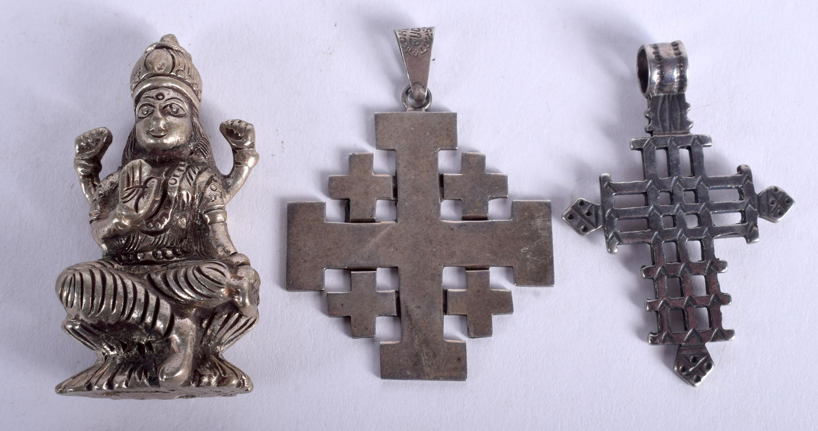 TWO SILVER PENDANTS and a buddha. (3) (1 of 2)