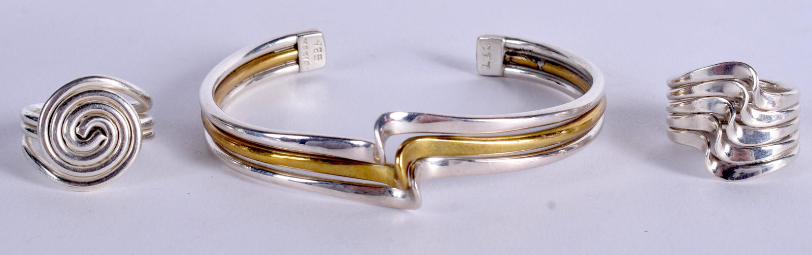 A STYLISH SILVER BANGLE with two silver rings. (3) (1 of 3)