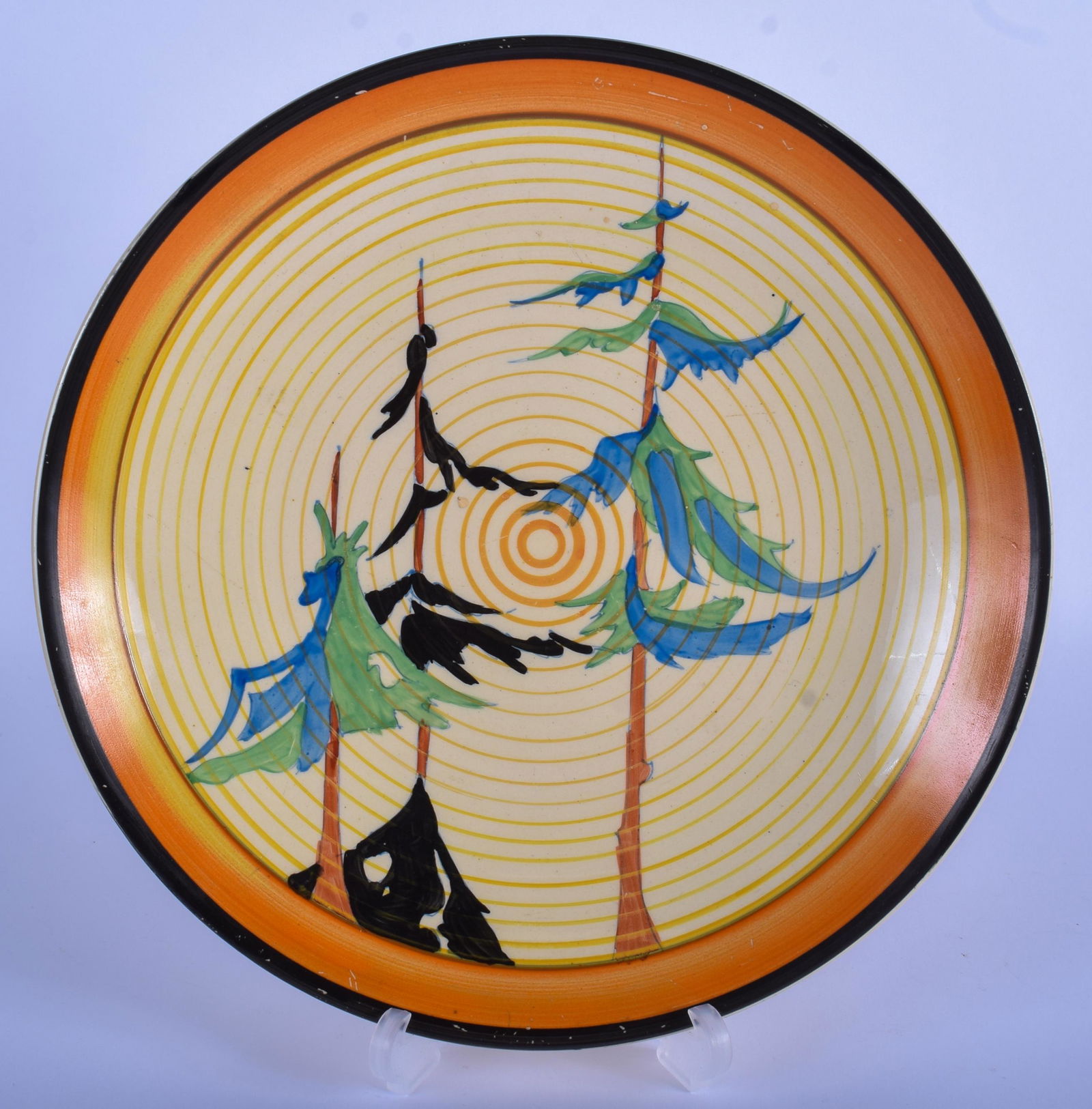 AN ART DECO CLARICE CLIFF BIZARRE PLATE painted with: AN ART DECO CLARICE CLIFF BIZARRE PLATE painted with trees. 23 cm diameter.