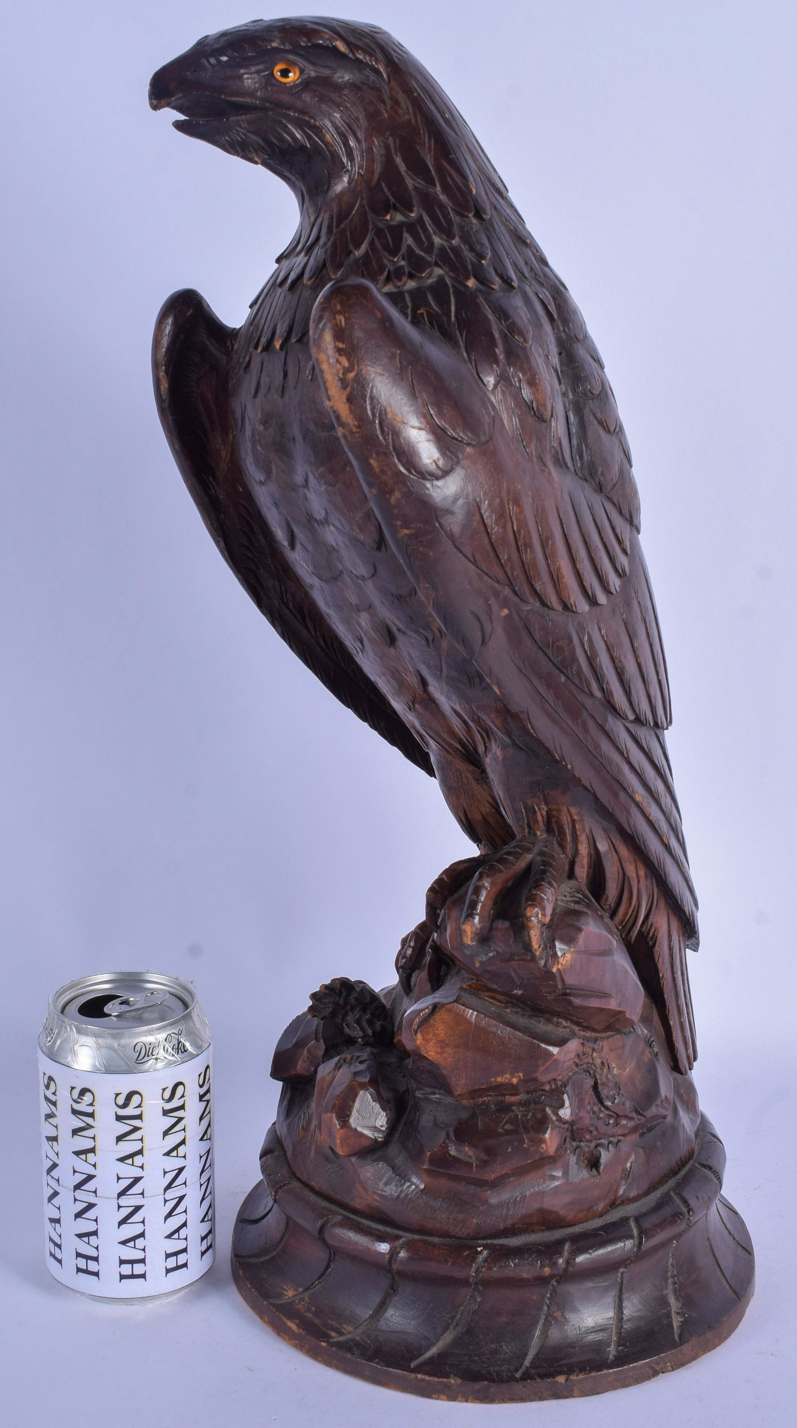 A LARGE 19TH CENTURY BAVARIAN BLACK FOREST MODEL OF A: A LARGE 19TH CENTURY BAVARIAN BLACK FOREST MODEL OF A HAWK modelled standing upon a naturalistic base. 46 cm high.