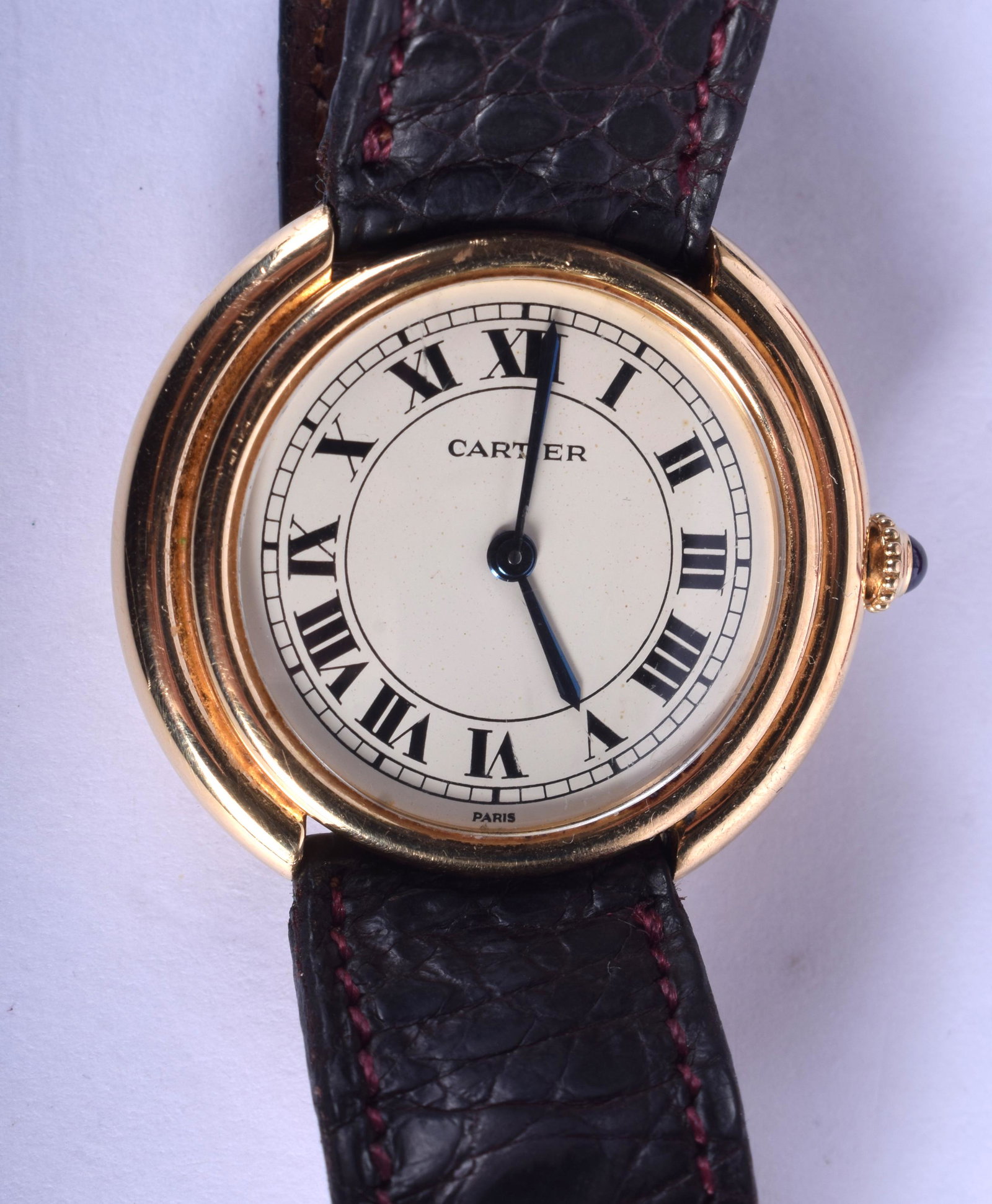 A BOXED 18CT GOLD FRENCH CARTIER LADIES CIRCULAR: A BOXED 18CT GOLD FRENCH CARTIER LADIES CIRCULAR WRISTWATCH with sapphire winder. 3.5 cm wide.