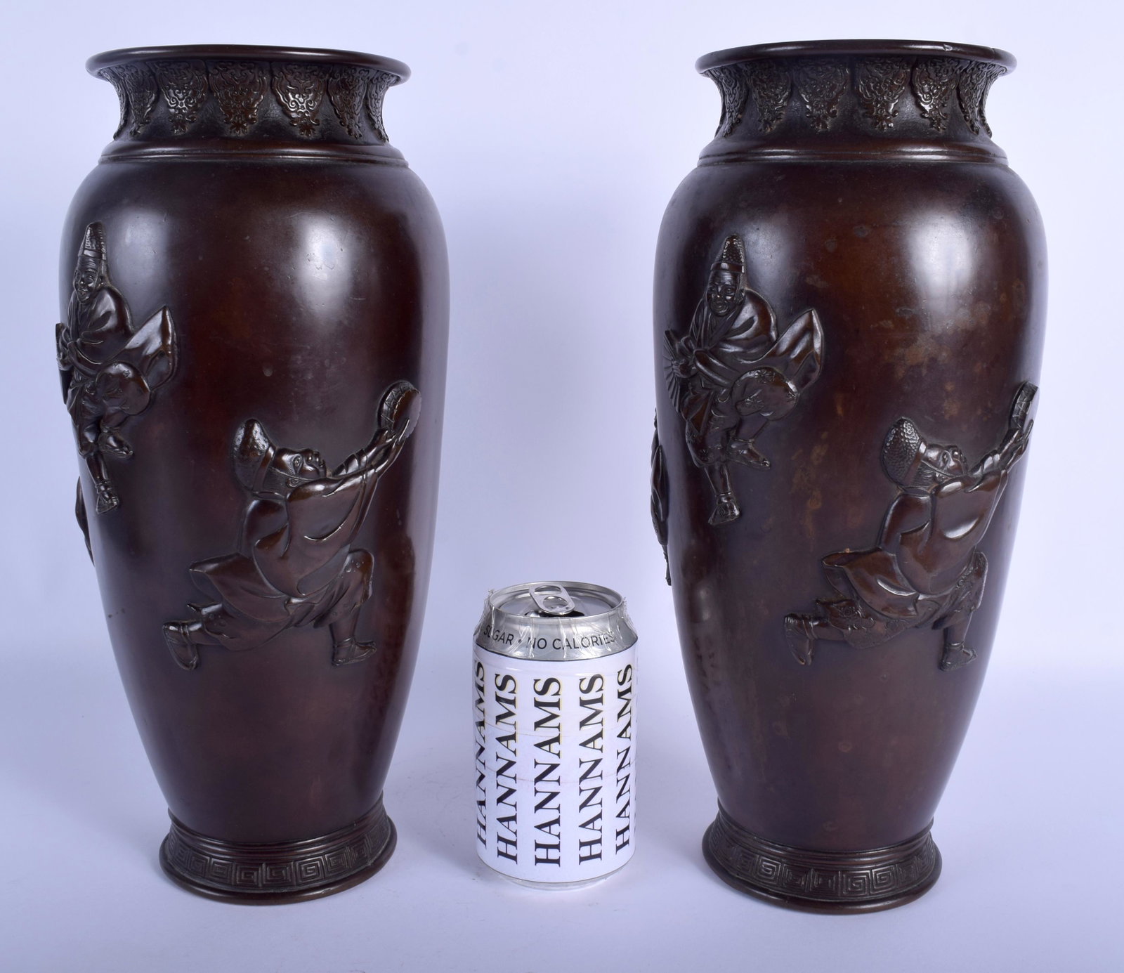 A LARGE PAIR OF 19TH CENTURY JAPANESE MEIJI PERIOD: A LARGE PAIR OF 19TH CENTURY JAPANESE MEIJI PERIOD BRONZE BULBOUS VASES decorated with dancing males within landscapes. 33 cm high.