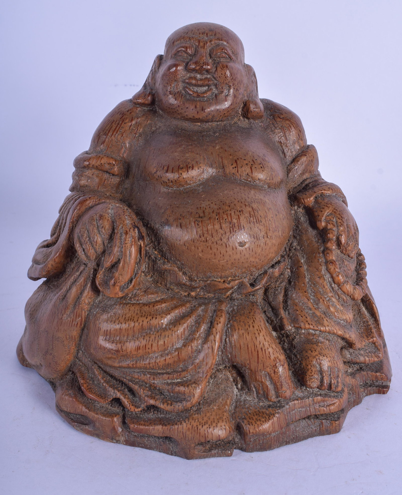 A 19TH CENTURY CHINESE CARVED BAMBOO FIGURE OF A BUDDHA: A 19TH CENTURY CHINESE CARVED BAMBOO FIGURE OF A BUDDHA modelled holding prayer beads. 15 cm x 12 cm.
