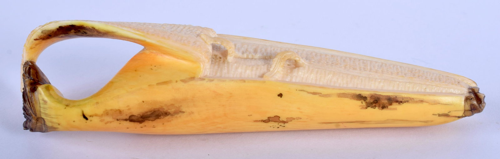 A 19TH CENTURY JAPANESE MEIJI PERIOD CARVED I BANANA of: A 19TH CENTURY JAPANESE MEIJI PERIOD CARVED I BANANA of naturalistic form. 12 cm x 3 cm.