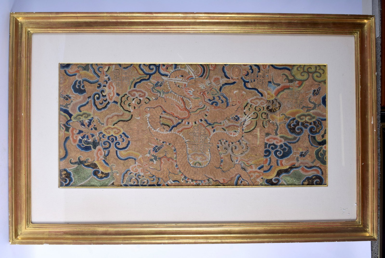 A RARE CHINESE MING DYNASTY SILK WORK EMBROIDERED: A RARE CHINESE MING DYNASTY SILK WORK EMBROIDERED DRAGON PANEL Wanli, decorated with foliage and vines. Silk 73 cm x 33 cm.