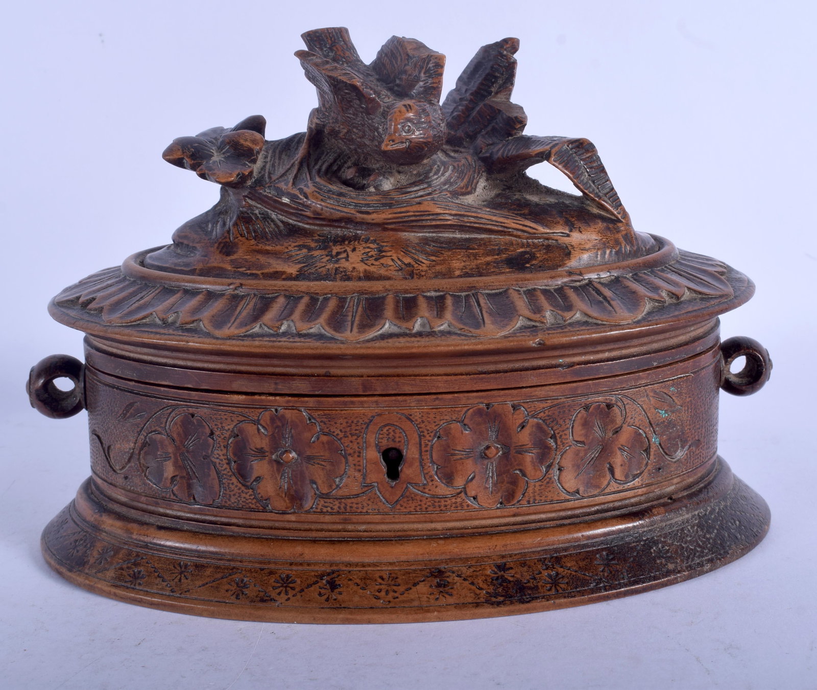 A 19TH CENTURY BLACK FOREST BAVARIAN CARVED WOOD CASKET: A 19TH CENTURY BLACK FOREST BAVARIAN CARVED WOOD CASKET with bird finial. 17 cm wide.