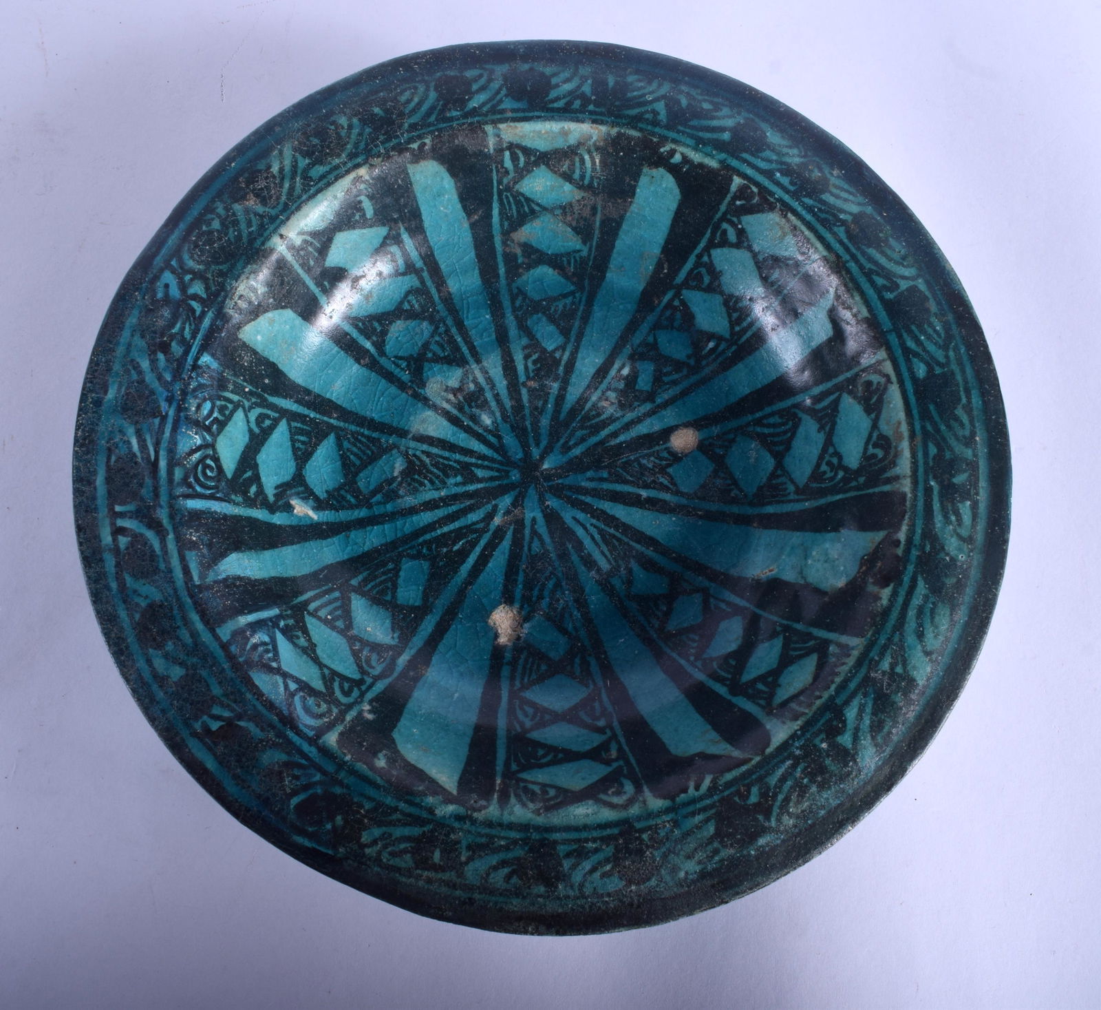 A 12TH/13TH CENTURY KASHAN UNDERGLAZE PAINTED POTTERY: A 12TH/13TH CENTURY KASHAN UNDERGLAZE PAINTED POTTERY BOWL Persia, painted with motifs on a turquoise ground. 19 cm wide.