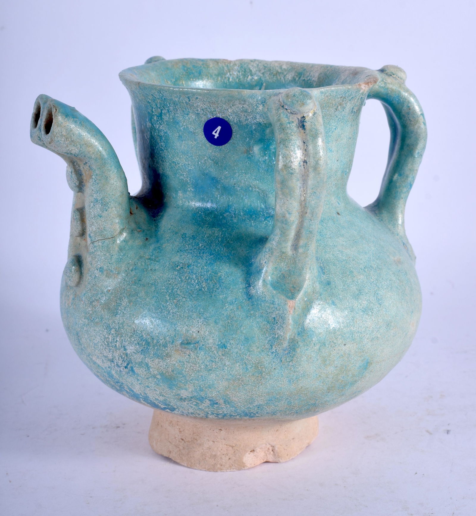 A 12TH/13TH CENTURY KASHAN UNDERGLAZE PAINTED POTTERY: A 12TH/13TH CENTURY KASHAN UNDERGLAZE PAINTED POTTERY JUG Persia, with unusual twin form spout. 12 cm high.