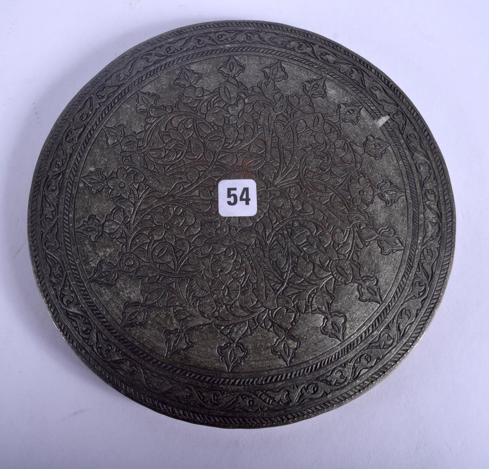 A 17TH CENTURY SAFAVID TINNED COPPER COVER Persia,: A 17TH CENTURY SAFAVID TINNED COPPER COVER Persia, decorated with foliage and motifs. 14 cm wide.