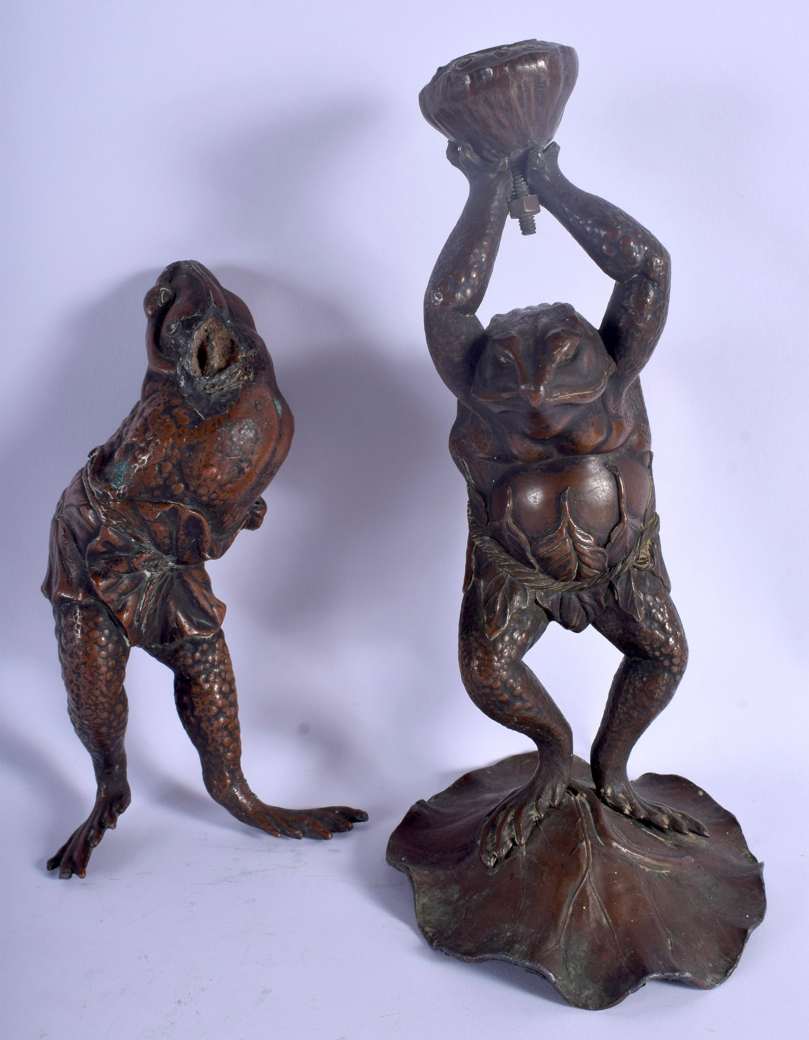 A PAIR OF 19TH CENTURY JAPANESE MEIJI PERIOD BRONZED: A PAIR OF 19TH CENTURY JAPANESE MEIJI PERIOD BRONZED LEAD FROGS modelled in various stances. 27 cm & 20 cm high. (2)