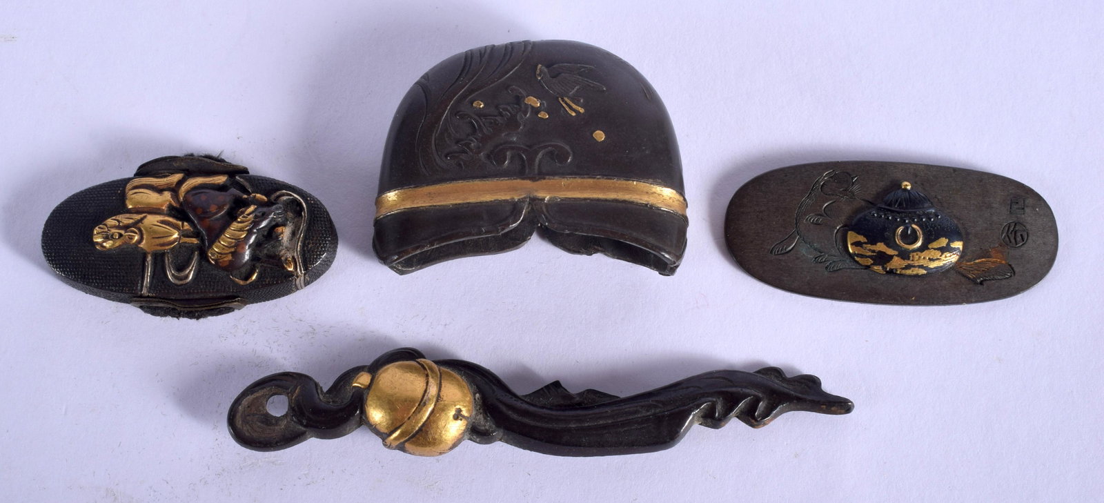FOUR 19TH CENTURY JAPANESE MEIJI PERIOD SWORD FITTINGS: FOUR 19TH CENTURY JAPANESE MEIJI PERIOD SWORD FITTINGS in various forms and sizes. (4)