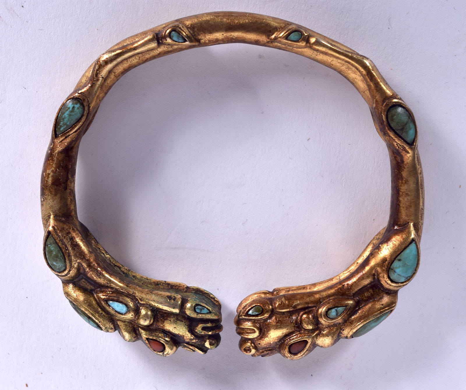 A CHINESE SINO TIBETAN YELLOW METAL BANGLE, formed with (1 of 2)