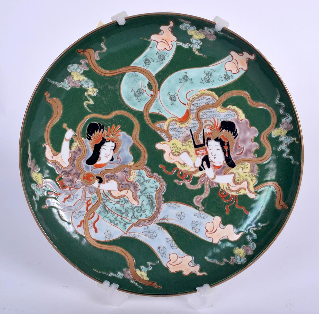 AN UNUSUAL JAPANESE MEIJI PERIOD GREEN GROUND KUTANI: AN UNUSUAL JAPANESE MEIJI PERIOD GREEN GROUND KUTANI PORCELAIN DISH, decorated with two females, signed. 25 cm wide.
