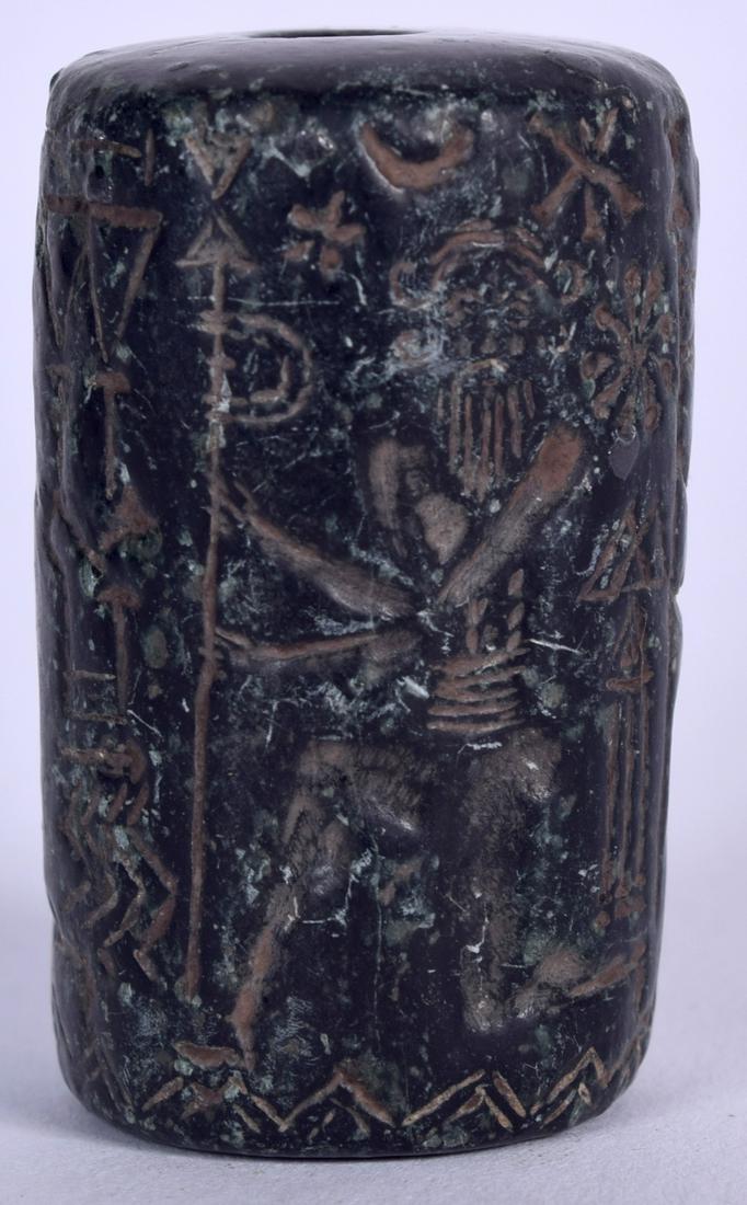 AN UNUSUAL EASTERN HARDSTONE BEAD, carved with figures: AN UNUSUAL EASTERN HARDSTONE BEAD, carved with figures and symbols. 3.75 cm long.