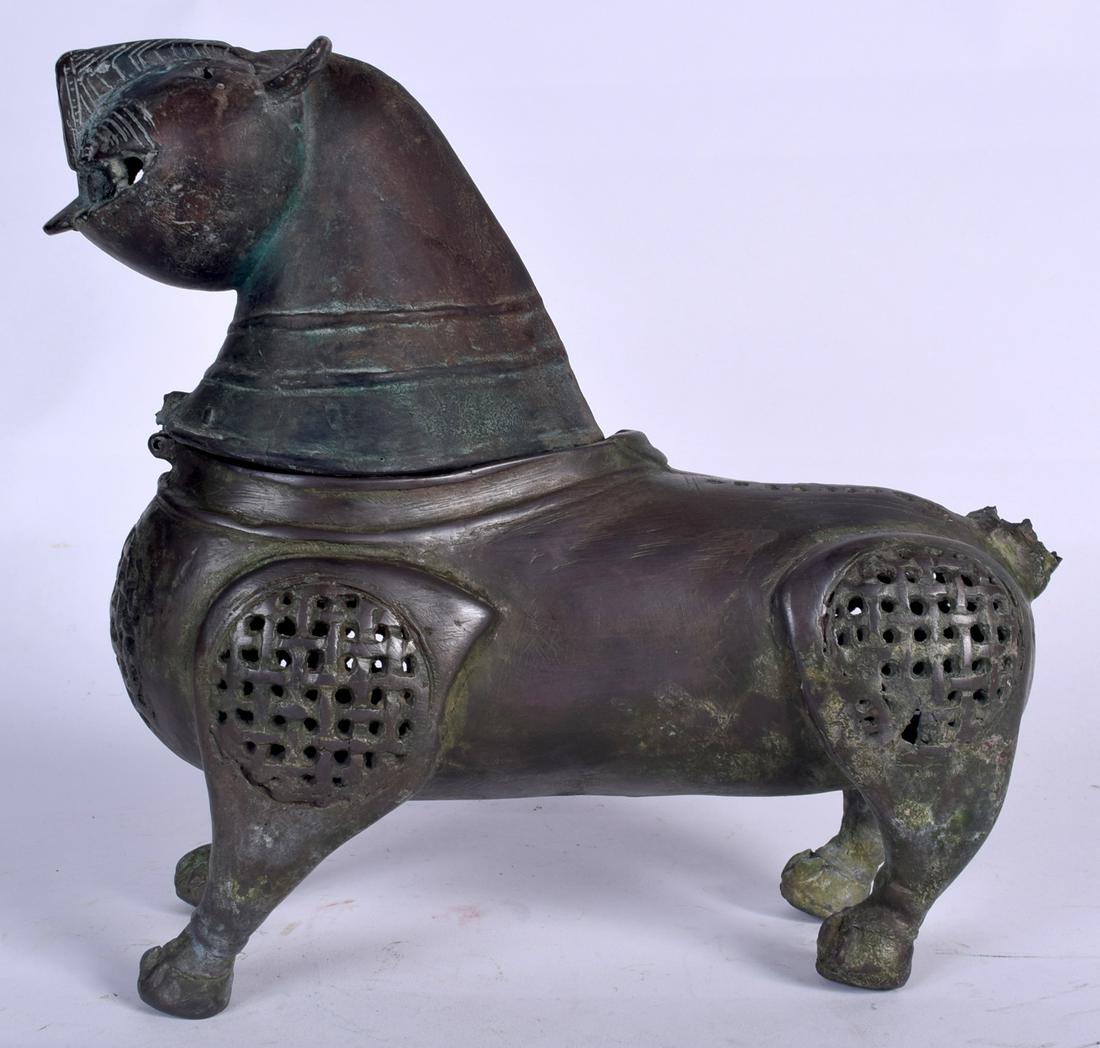 AN ISLAMIC BRONZE INCENSE BURNER, in the form of a (1 of 2)
