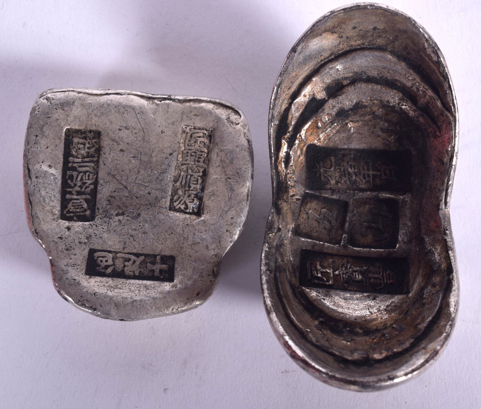 TWO CHINESE WHITE METAL INGOTS, varying design. Largest (1 of 2)