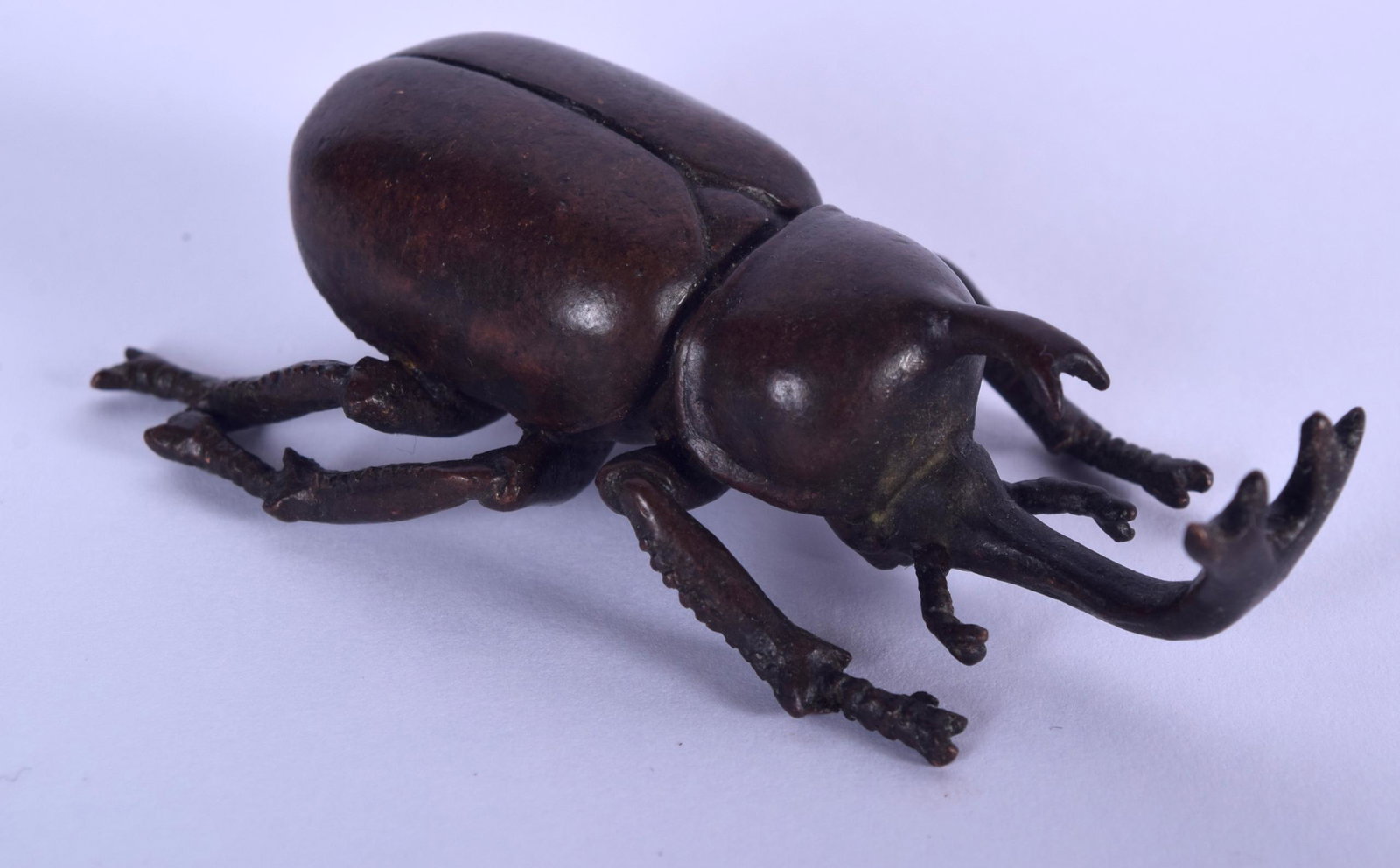 A JAPANESE BRONZE OKIMONO IN THE FORM OF A LONG HORN: A JAPANESE BRONZE OKIMONO IN THE FORM OF A LONG HORN BEETLE, signed. 7 cm long.