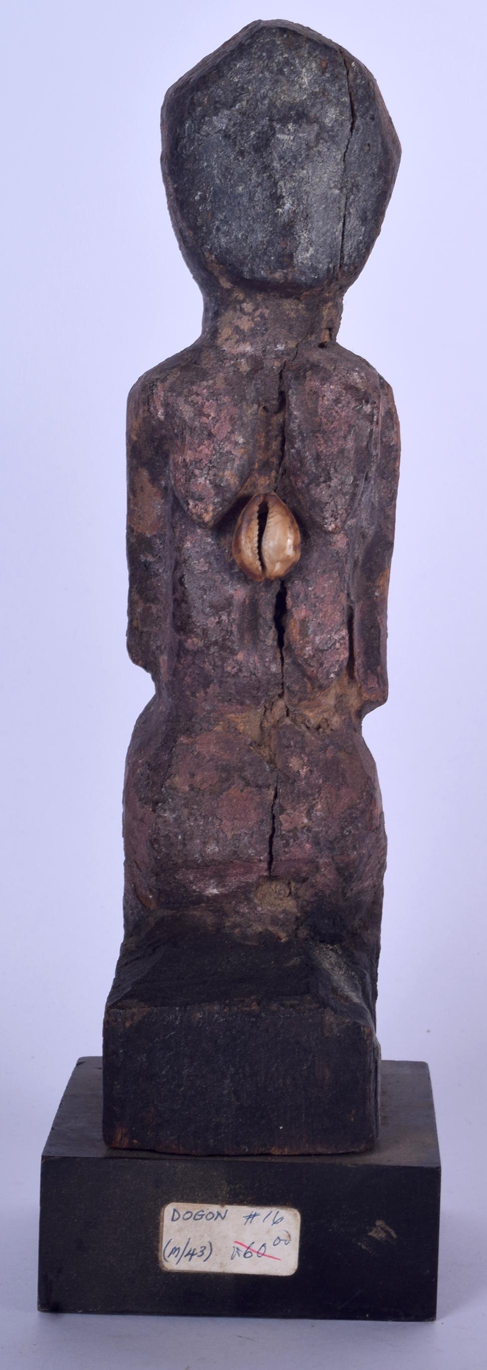 A MALIAN DOGON CARVED WOODEN FIGURE, inset with shell (1 of 2)