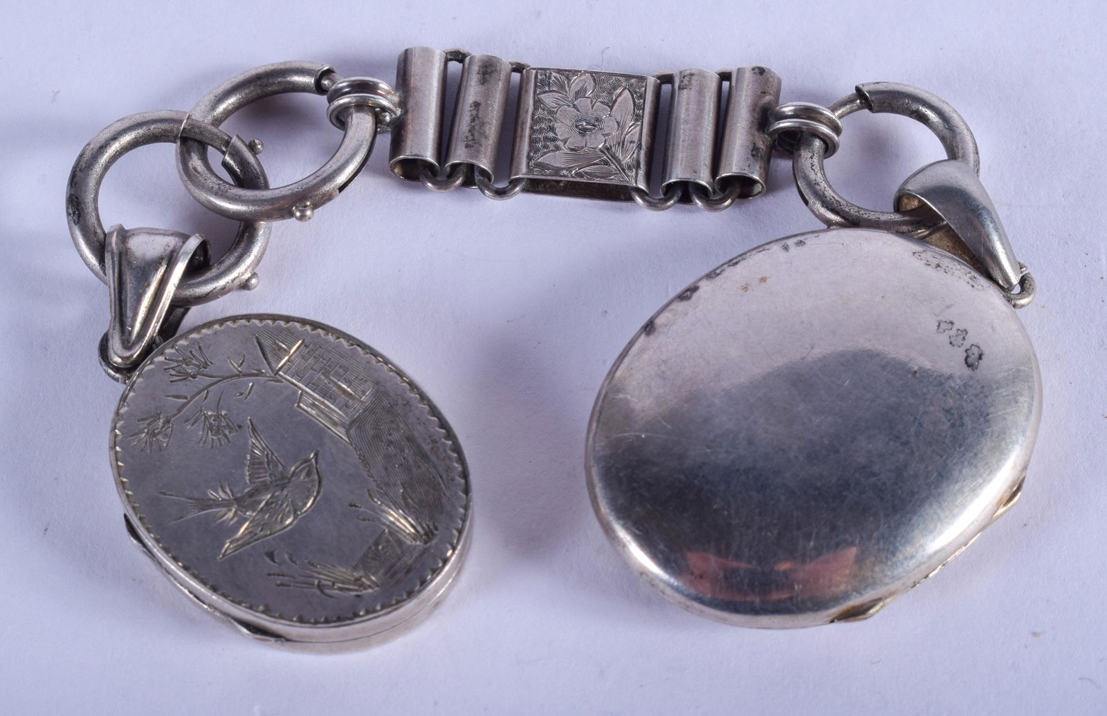 A VICTORIAN AESTHETIC MOVEMENT SILVER LOCKET on chain. (1 of 2)