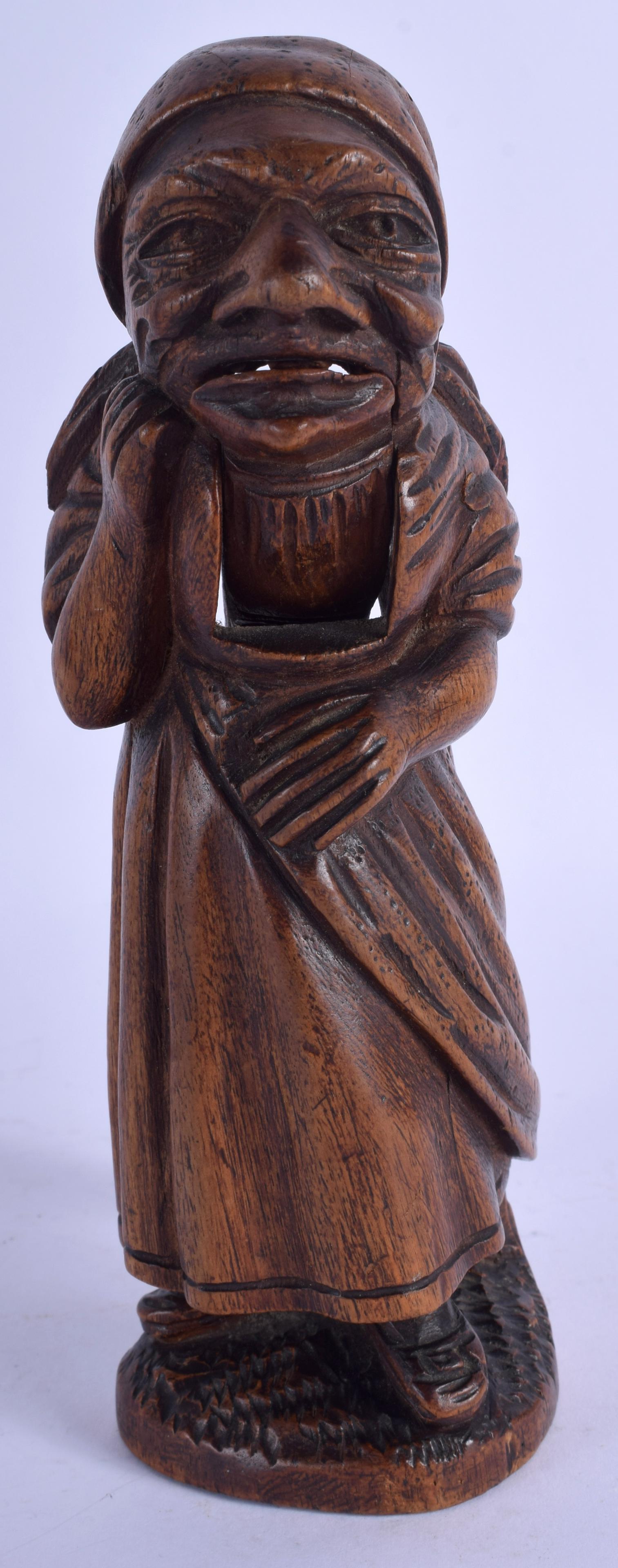 A BAVARIAN BLACK FOREST NUT CRACKER, formed as a: A BAVARIAN BLACK FOREST NUT CRACKER, formed as a standing female. 18.5 cm long.